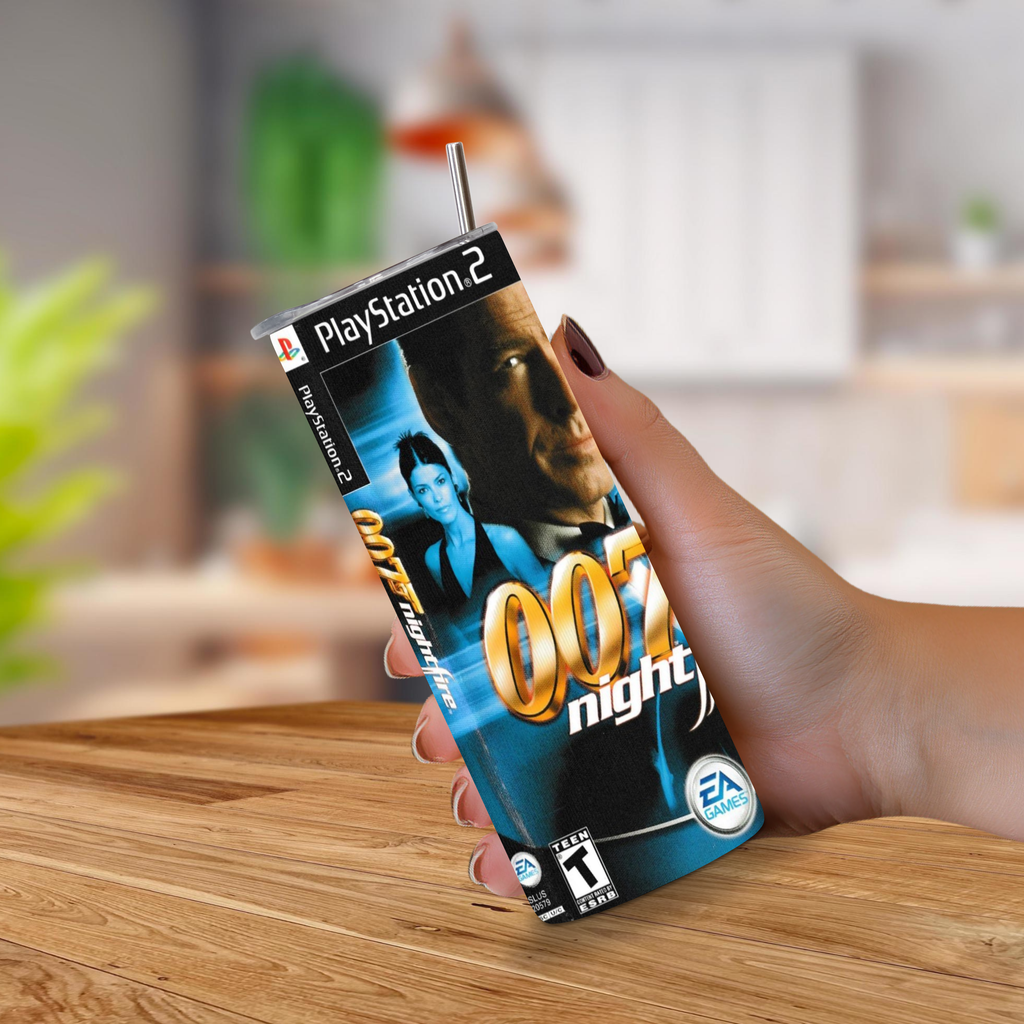 A hand holding a 20oz tumbler designed to look like a PlayStation 2 007 Night Fire game case, with a metal straw sticking out of the top, set against a blurred kitchen background.