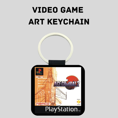 A PlayStation-themed art keychain featuring the 'Ace Combat 2' cover art on a black square tag with a silver key ring, shown against a light gray background with the text 'VIDEO GAME ART KEYCHAIN' above it.