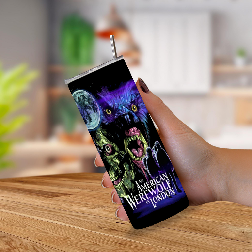 A hand holding a 20oz tumbler with movie graphics from "An American Werewolf in London" on a blurred background 