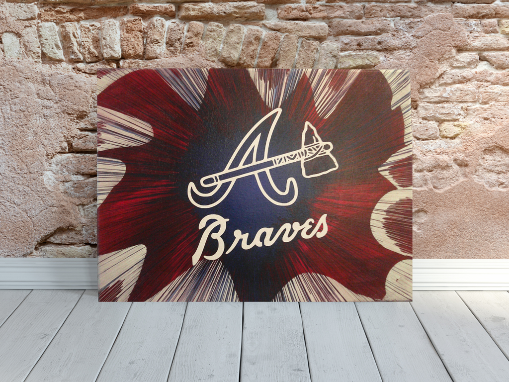 Atlanta Braves Spin Art canvas wall art against a brick wall.