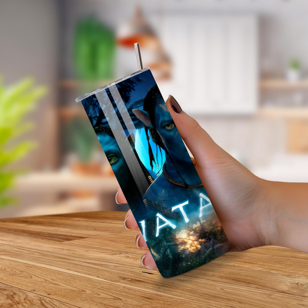 Person holding a tumbler with 'Avatar' design on a wooden surface