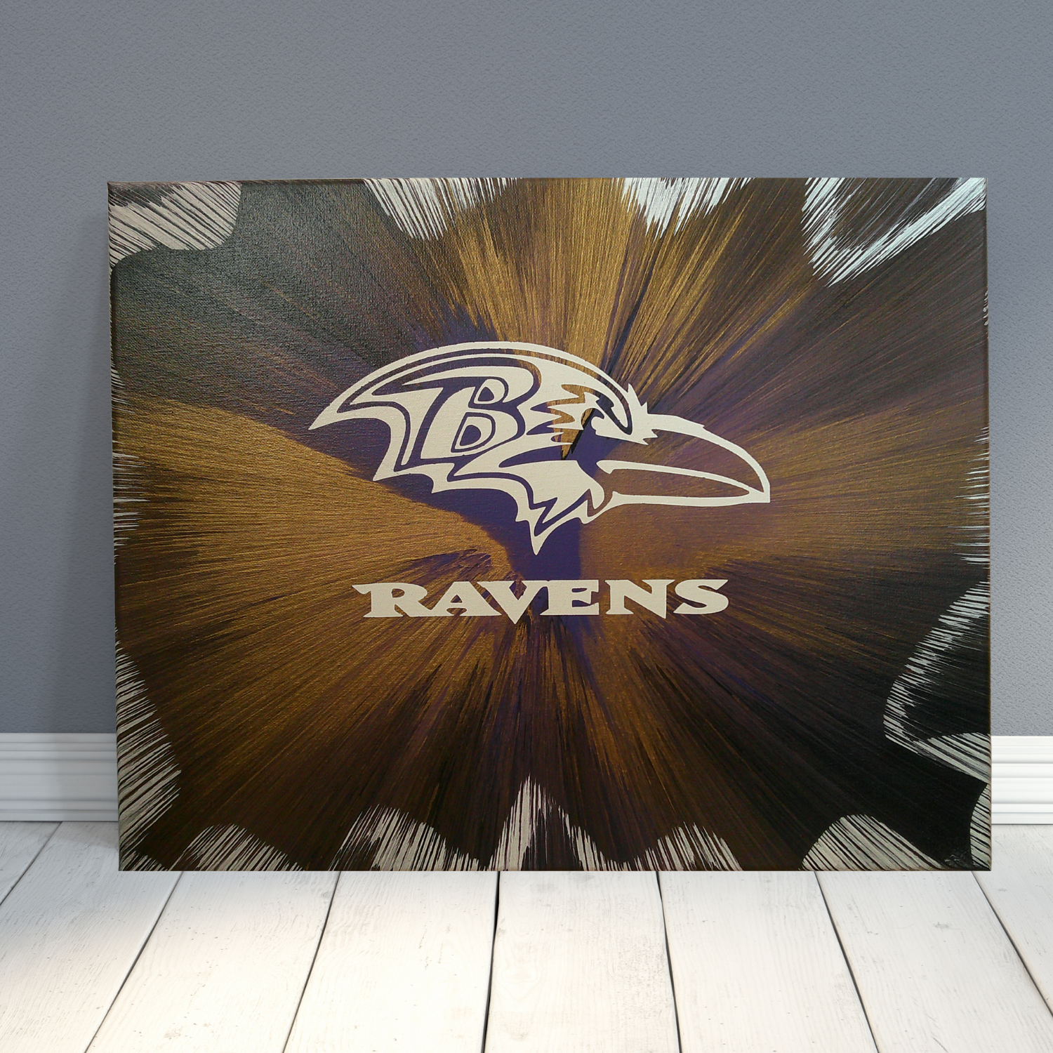 Baltimore Ravens logo on a spin art canvas with sunburst design against a gray wall.