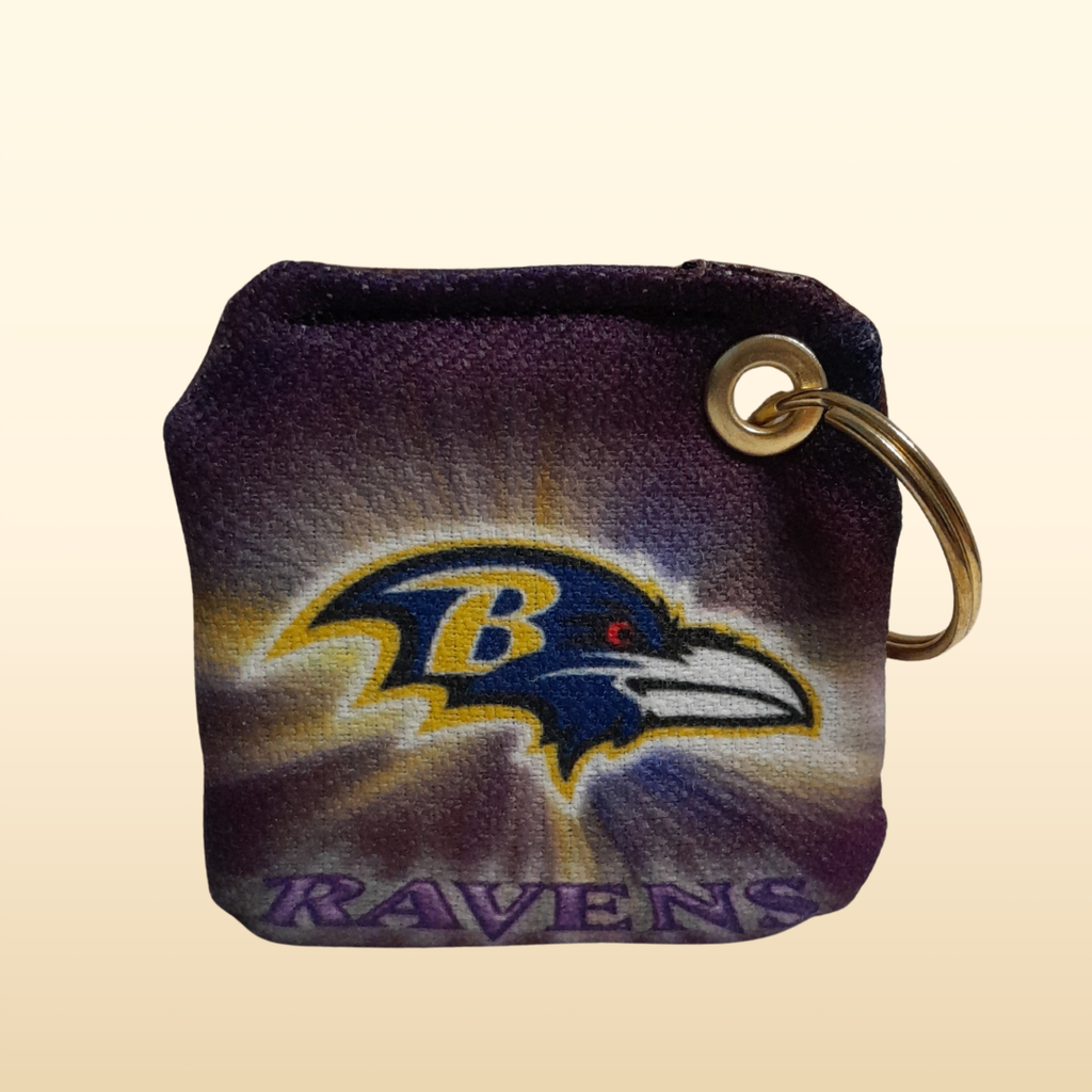 Keychain with Baltimore Ravens logo on a beige background