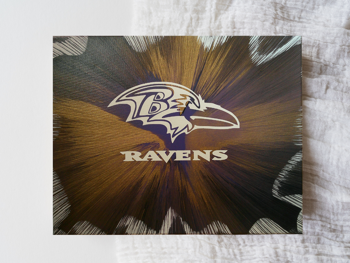 Baltimore Ravens logo on a spin art canvas with a starburst design