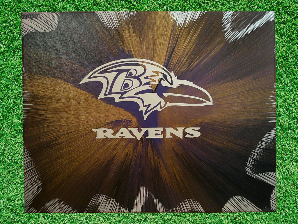 Ravens logo on a spin art canvas with grass background