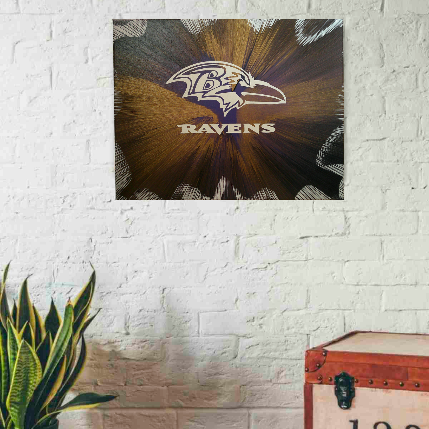 Baltimore Ravens Spin Art on a white wall with a plant and trunk in the foreground