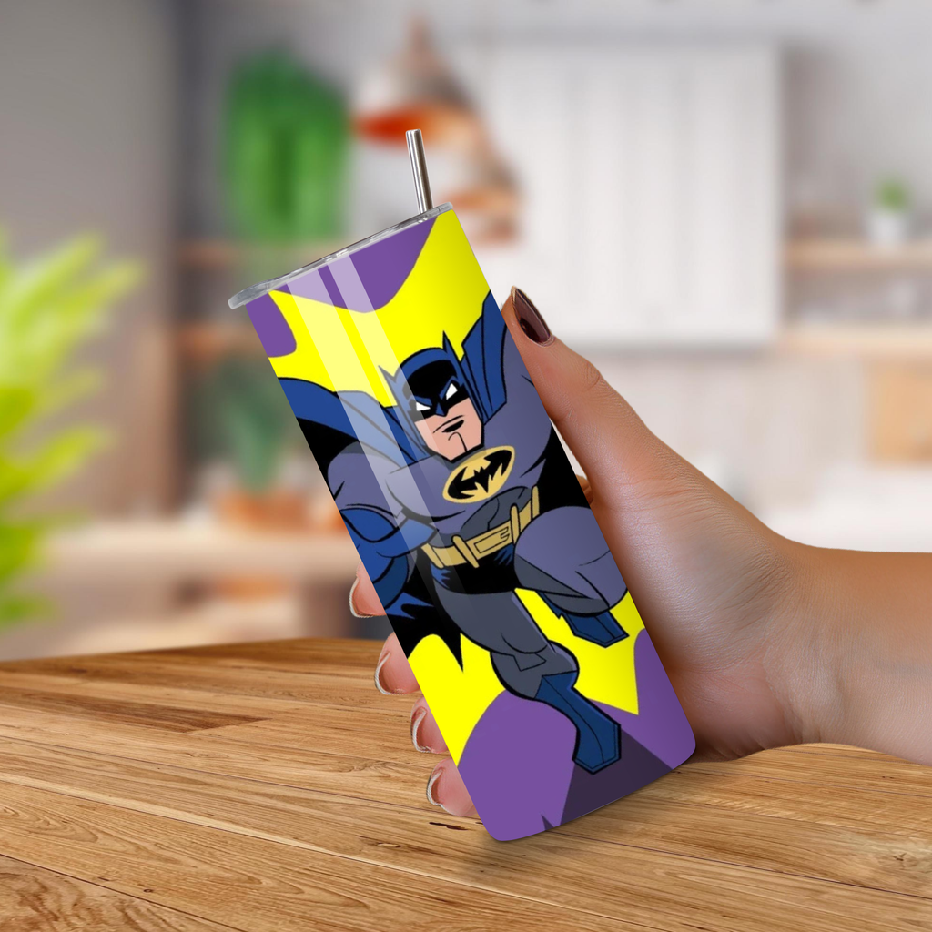 Tumbler with Batman design held by a hand on a wooden surface