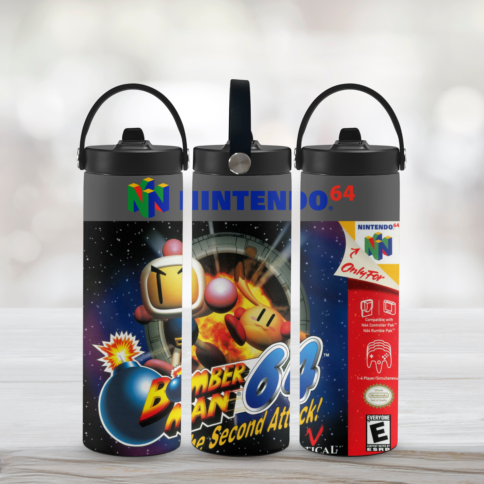 Three tumbler water bottles with Nintendo-themed design Bomber Man on a light wooden surface.
