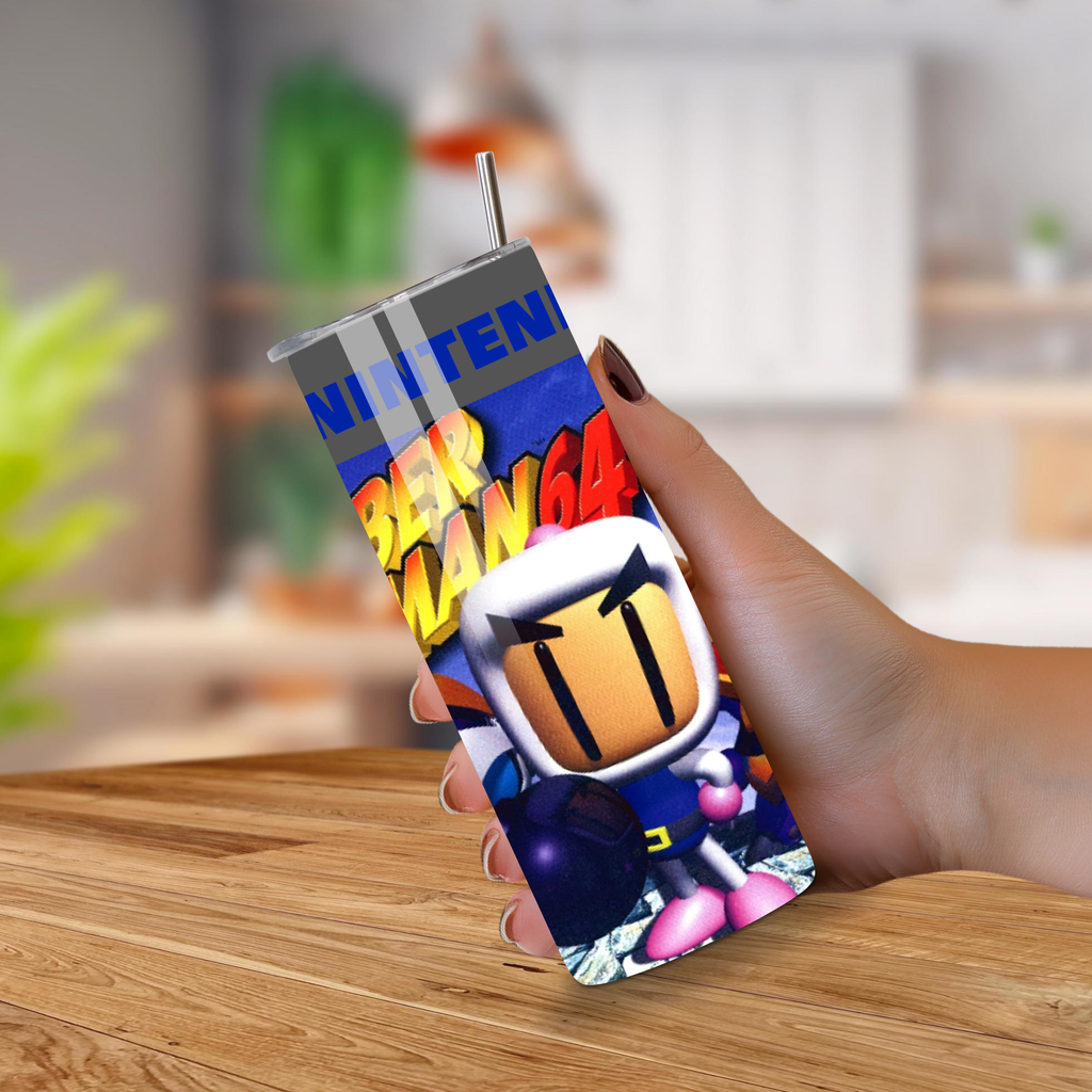 20oz tumbler with a colorful design featuring bomberman and 'Nintendo' branding, held by a hand on a wooden surface.