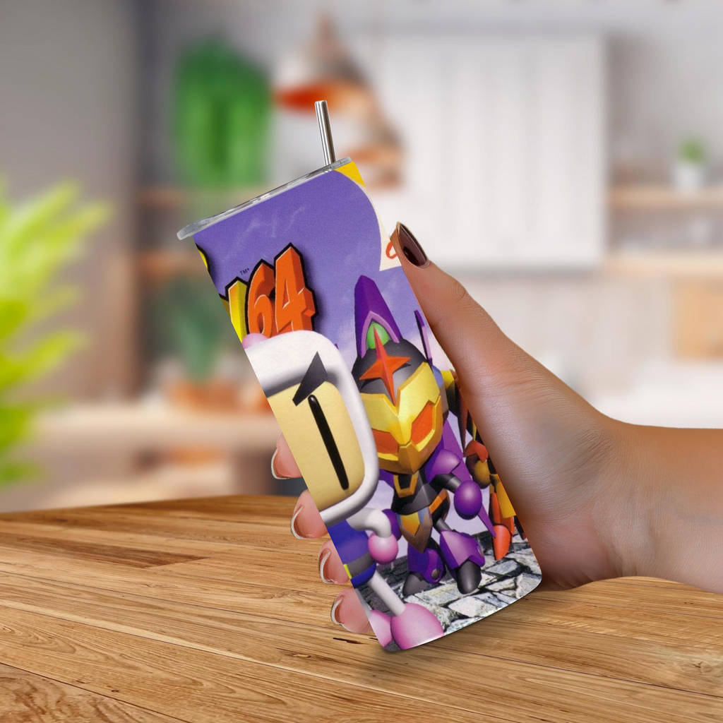 A hand holding a custom 20oz stainless steel tumbler with a metal straw, featuring a Bomberman 64 design on a purple background, set against a blurred kitchen background.