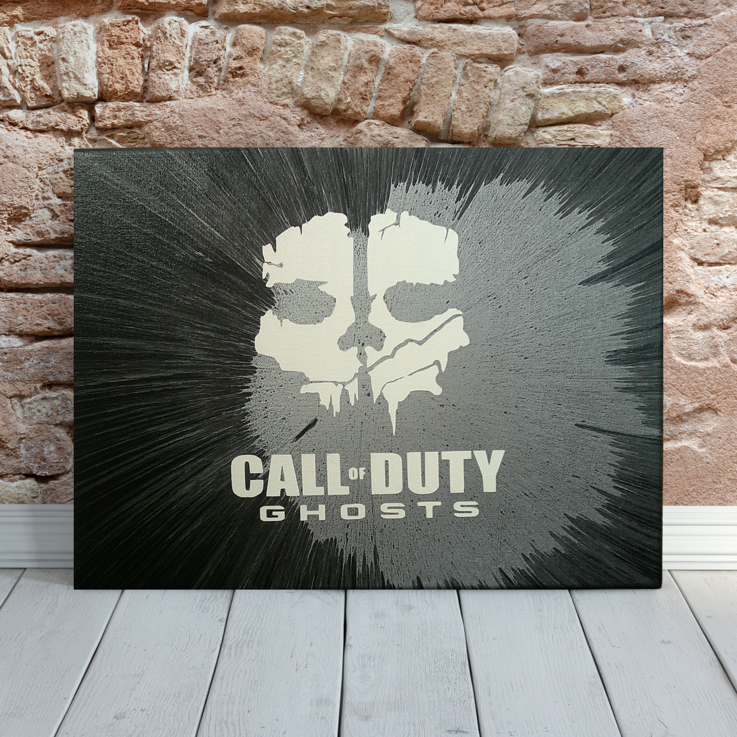 Call of Duty spin art canvas against a brick wall.