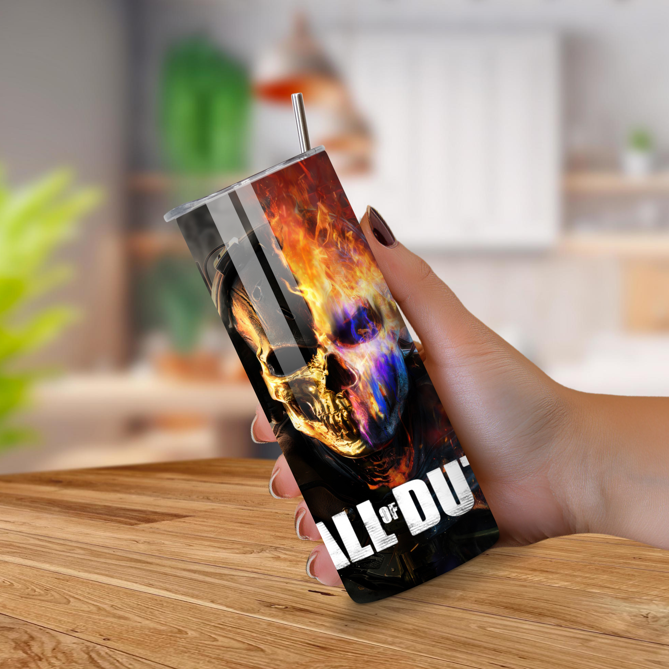 Tumbler with colorful Call of Duty design held by a hand on a wooden surface