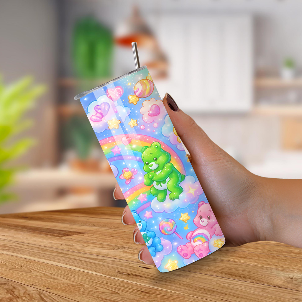 Colorful tumbler with Care bears cartoon designs held by a hand on a wooden surface.