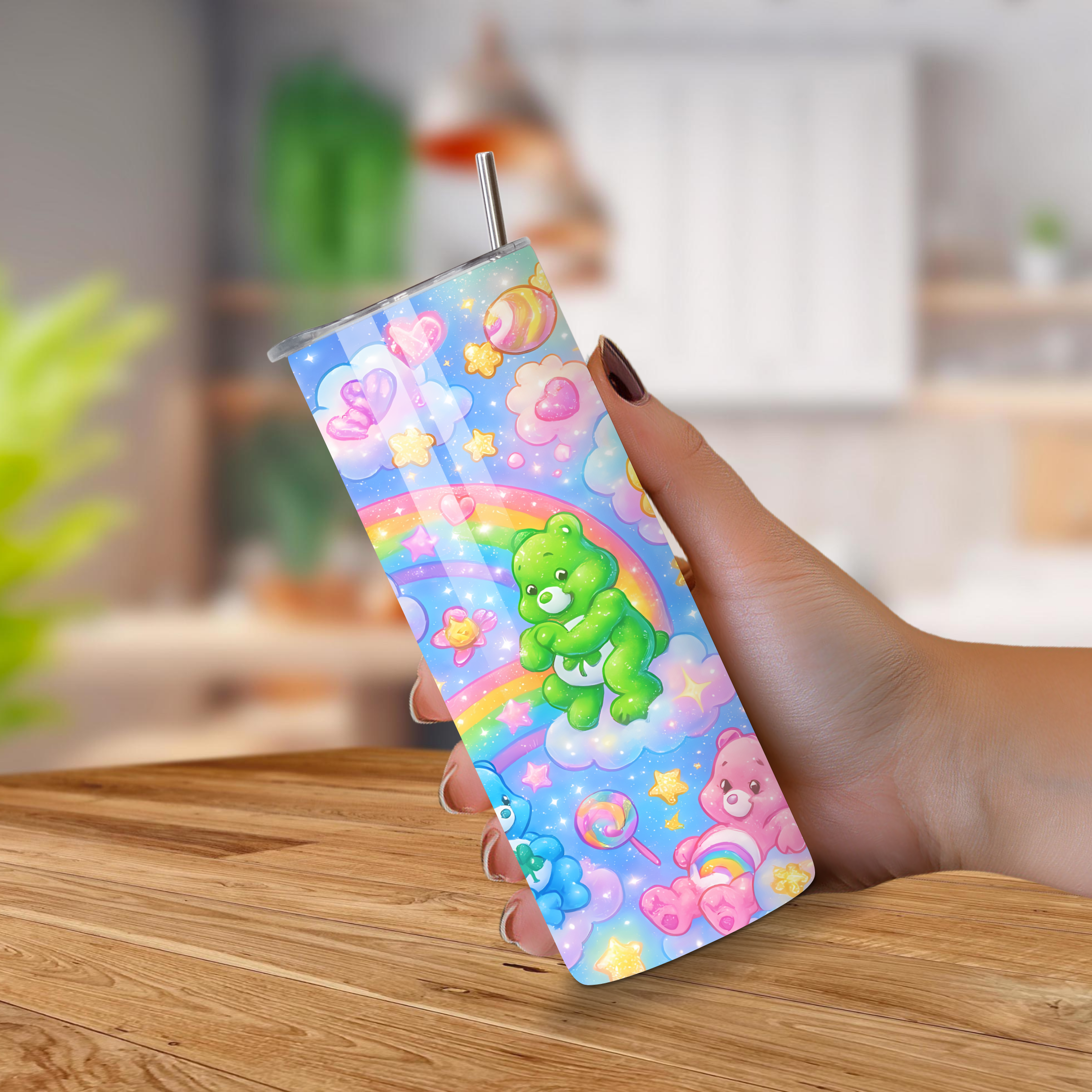 Colorful tumbler with Care bears cartoon designs held by a hand on a wooden surface.