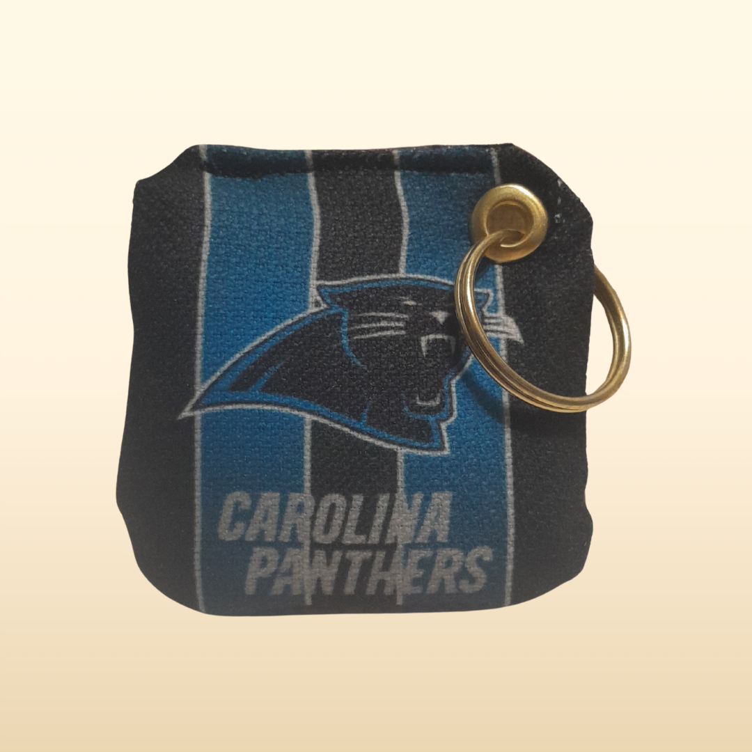 Carolina Panthers keychain pouch with logo on a beige background