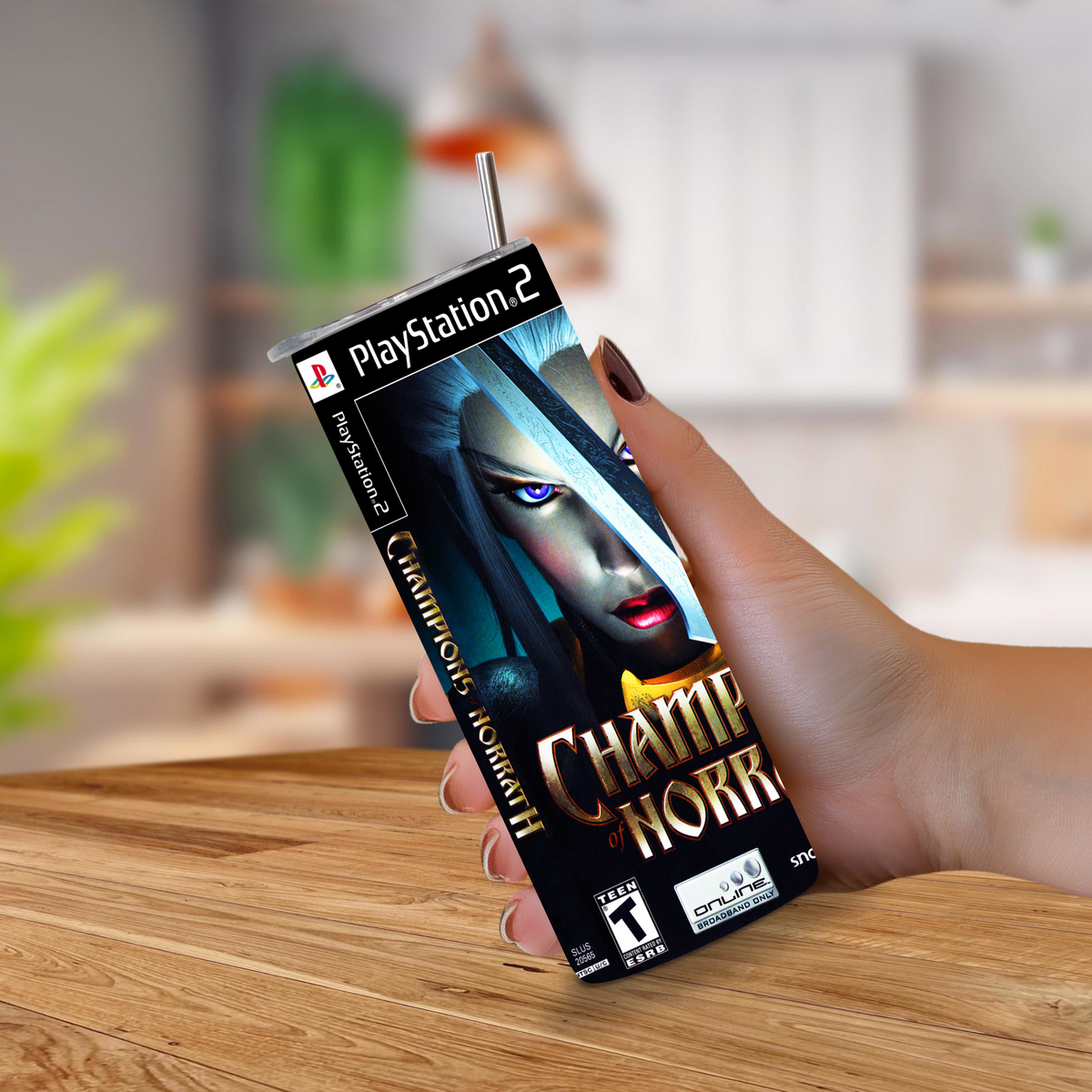 A hand holding a PlayStation 2 game cover designed to look like a 20oz stainless steel tumbler, featuring Champions of Norrath, set against a blurred kitchen background.