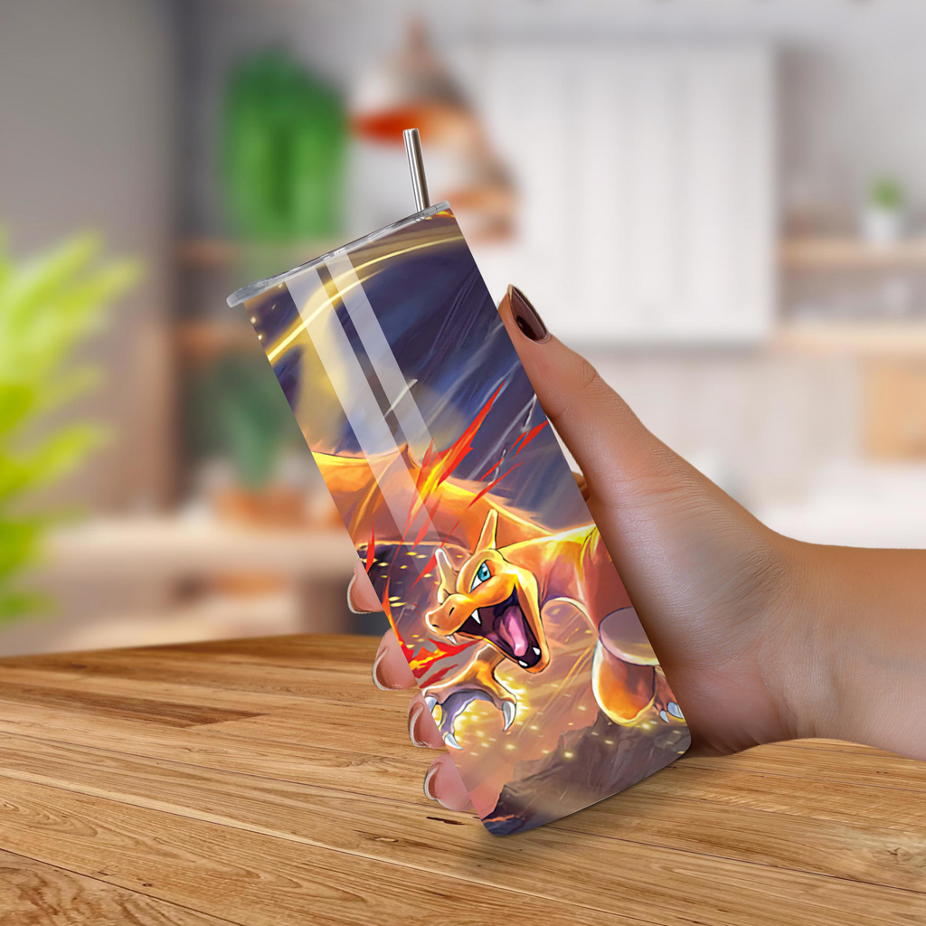 Hand holding a tumbler with a dragon design on a wooden surface