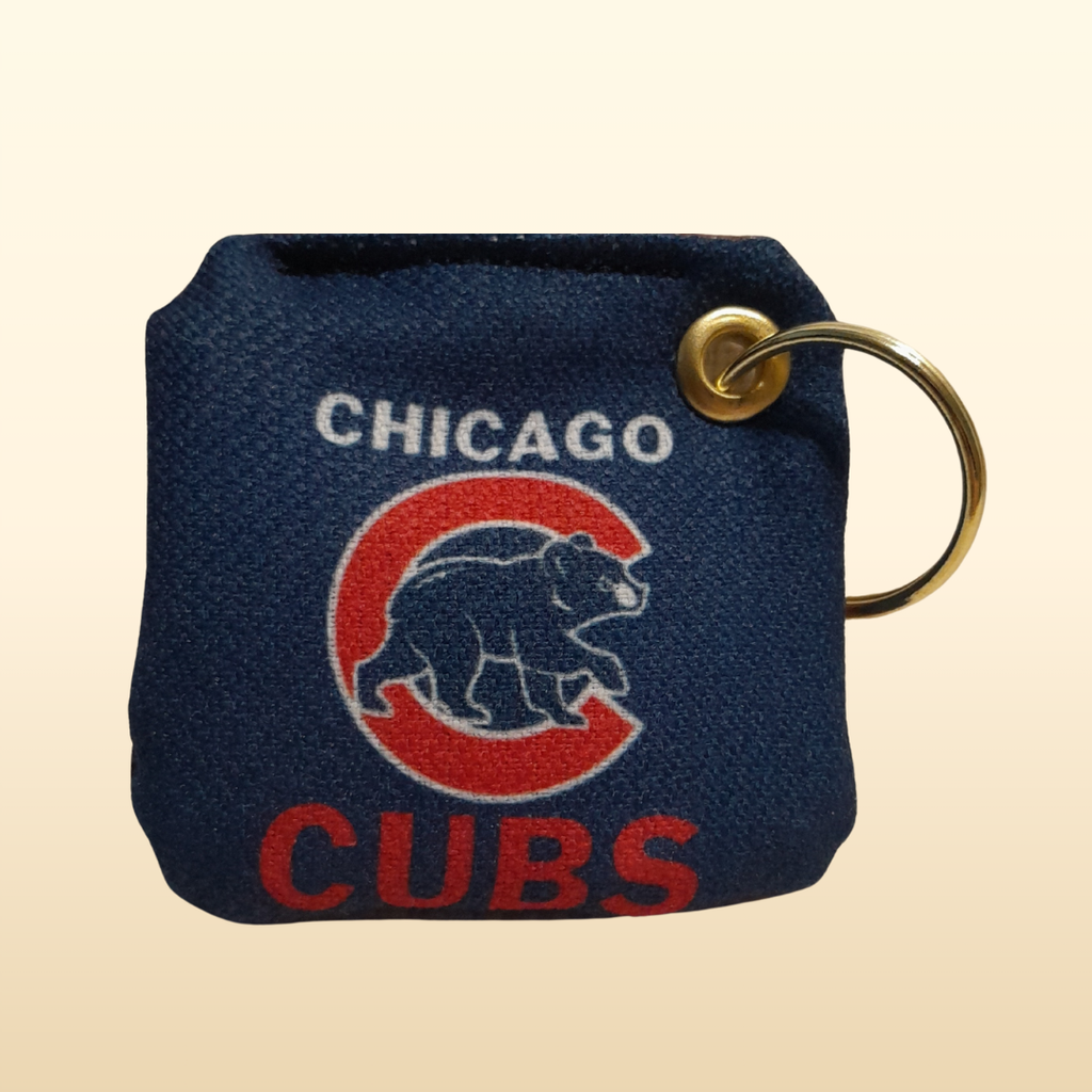 Navy blue keychain pouch with Chicago Cubs logo on a beige background