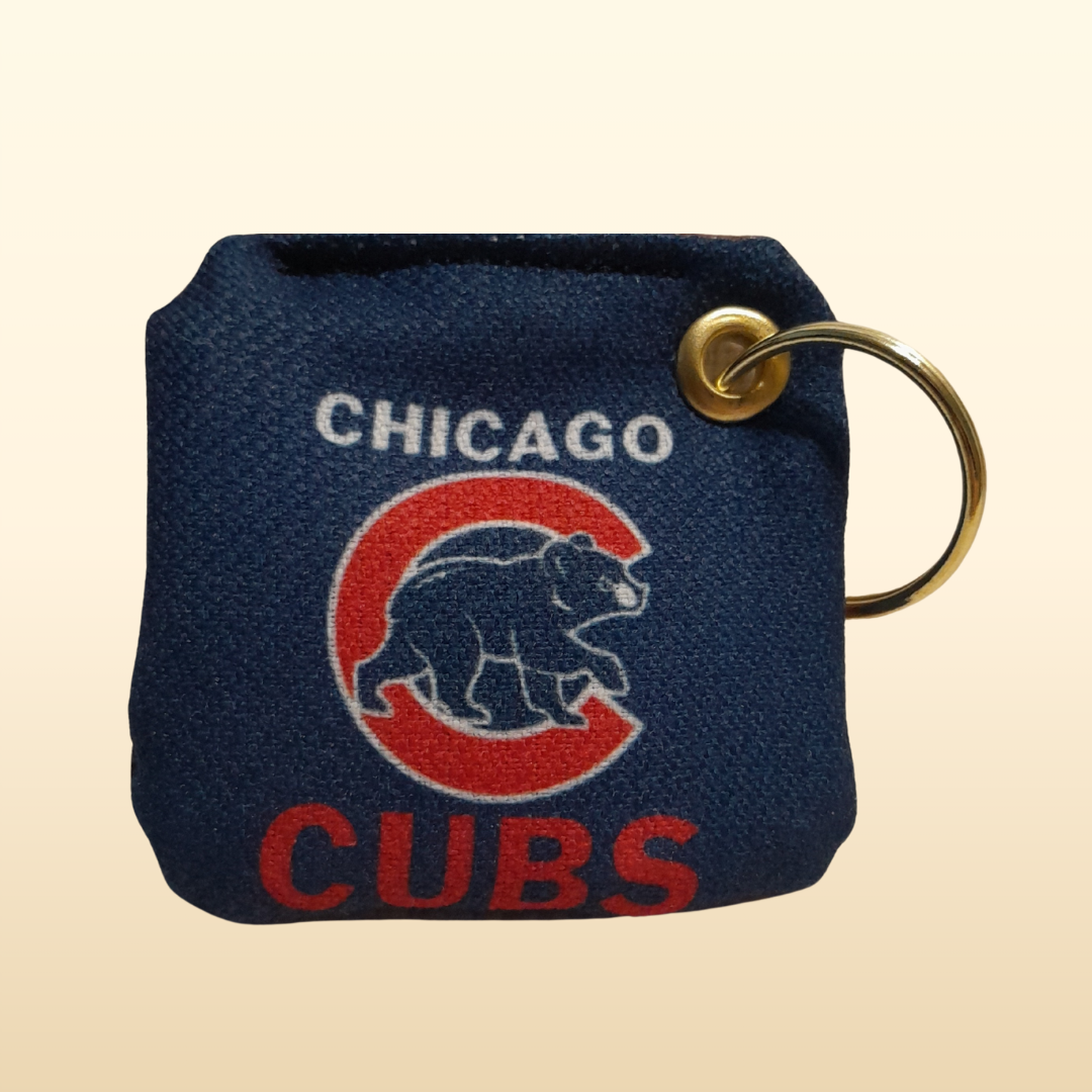 Navy blue keychain pouch with Chicago Cubs logo on a beige background