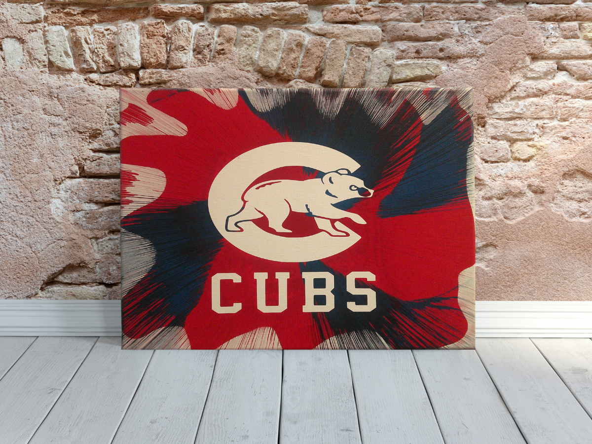 Chicago Cubs Spin Art canvas wall art against a brick wall.