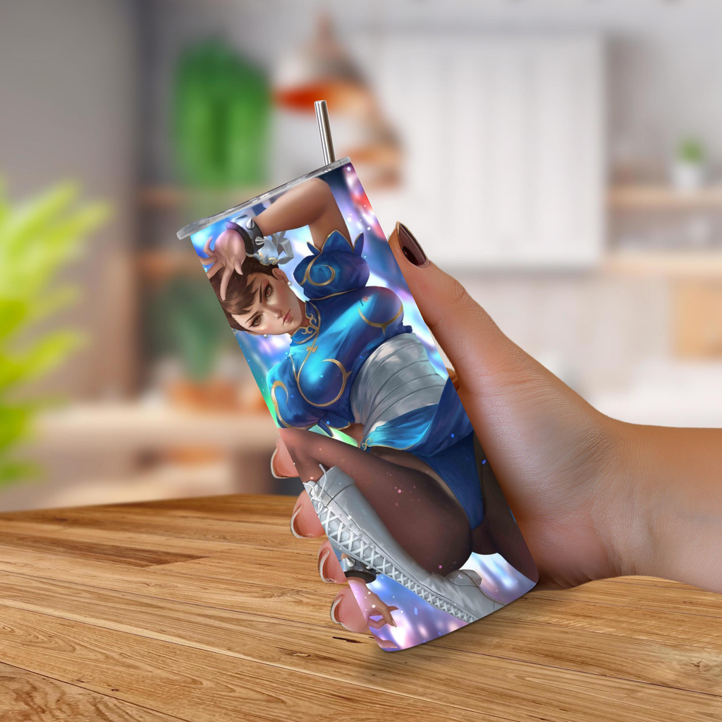 Person holding a 20oz tumbler with a Street Fighter Chun-Li design on a wooden surface