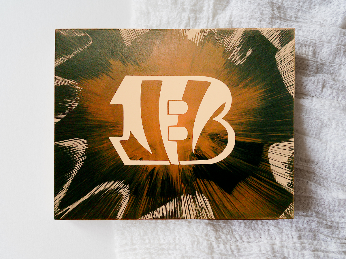 Cincinnati Bengals Spin Art canvas on a textured surface