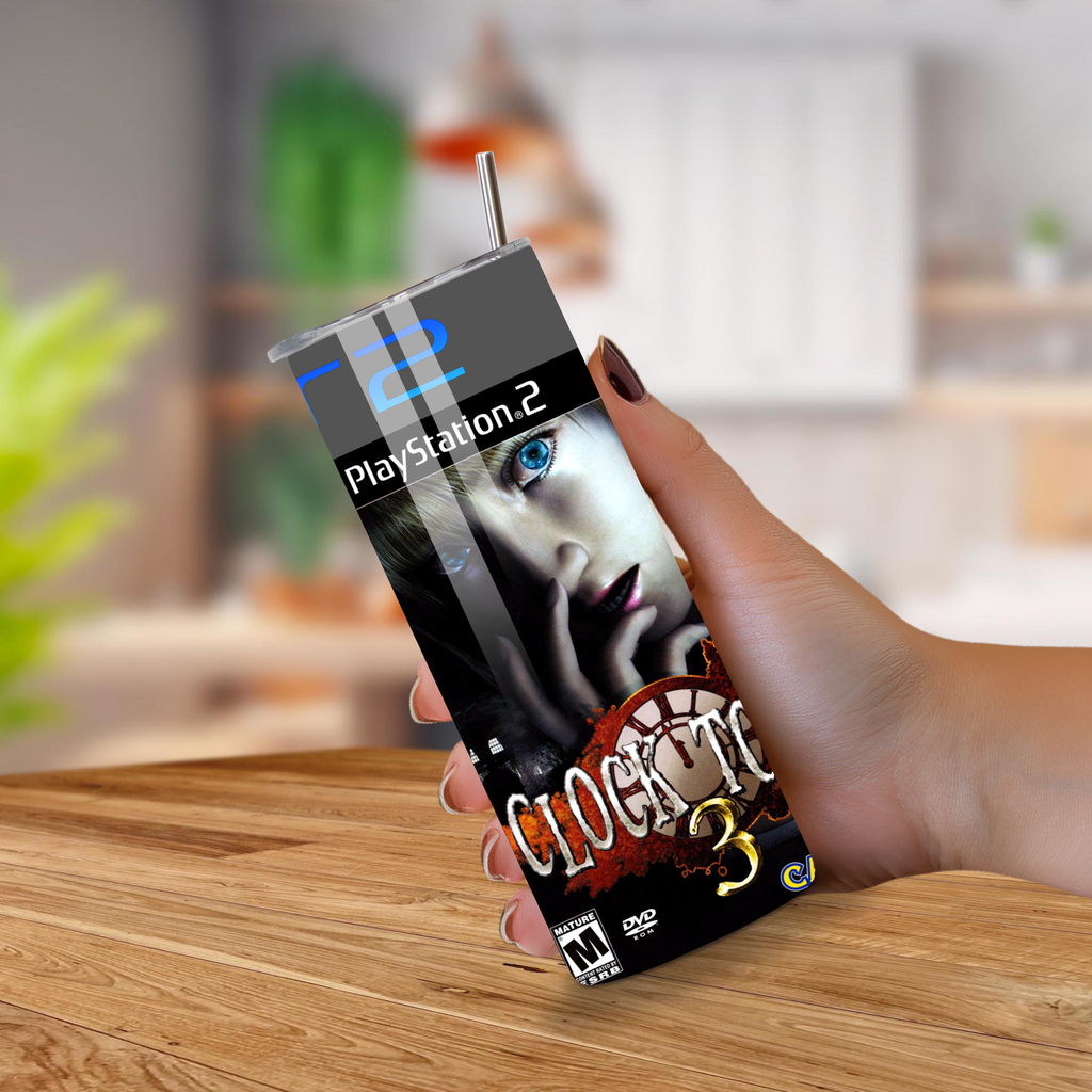 Hand holding a PlayStation 2 clock tower branding tumbler with a blurred indoor background