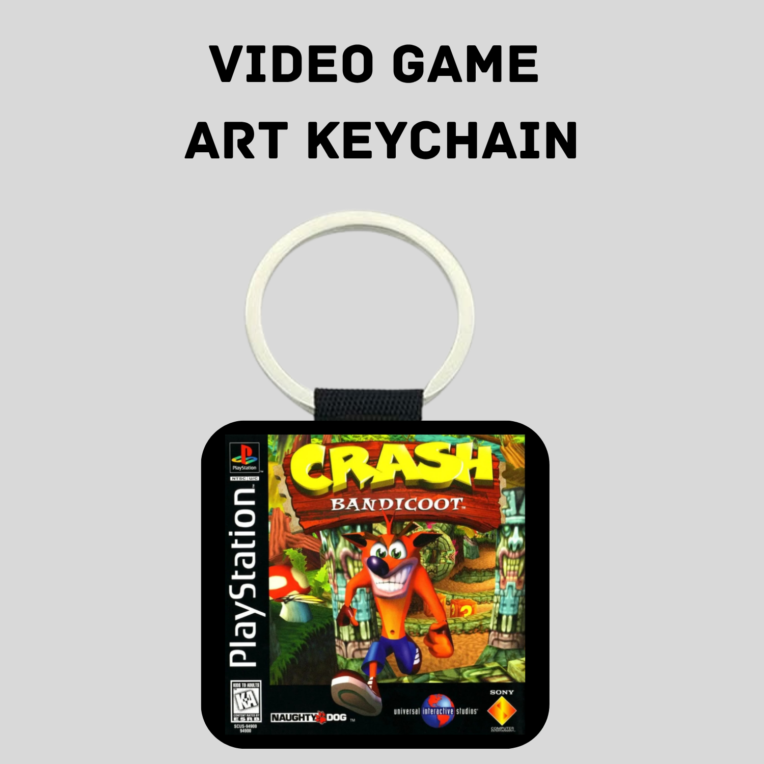 A Crash Bandicoot video game art keychain featuring the PlayStation logo and Crash's colorful character art, with a white key ring on a light gray background.