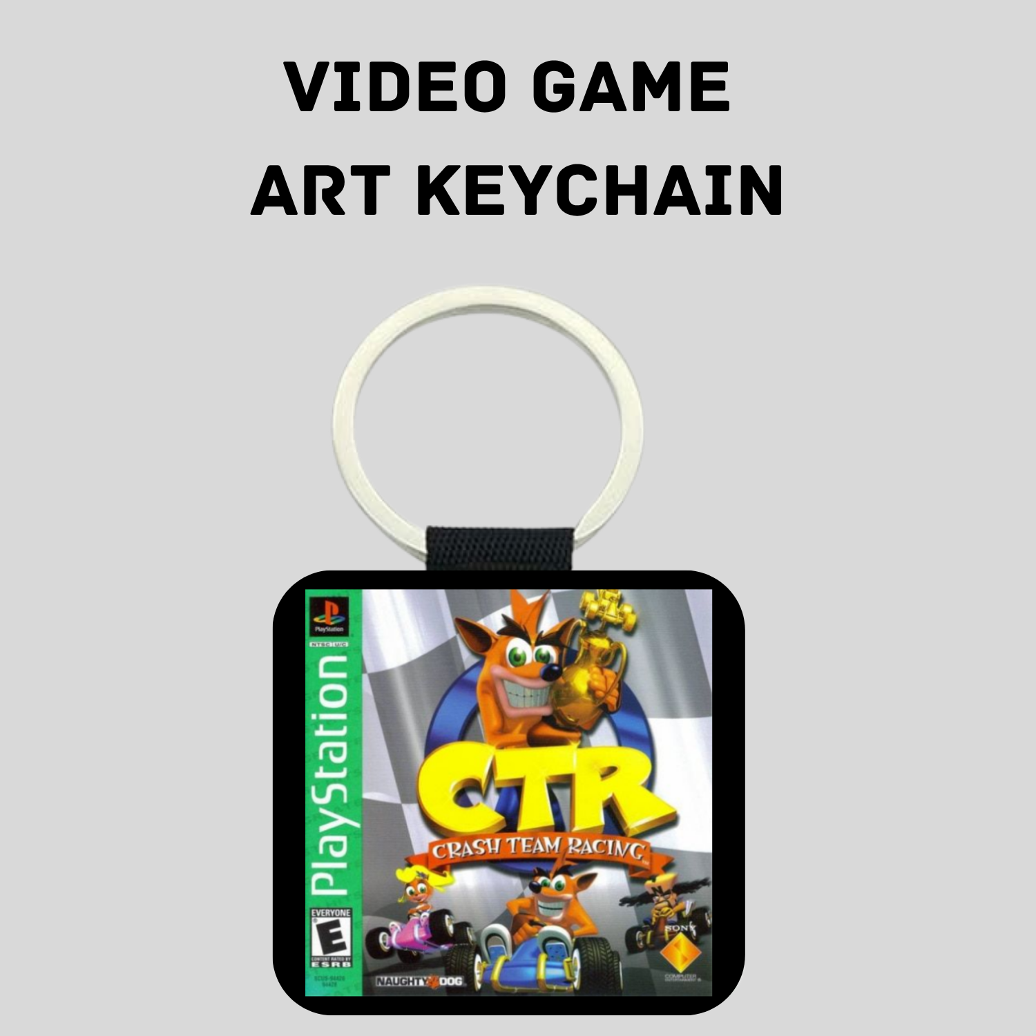 A PlayStation CTR Crash Team Racing art keychain with a white split ring and black strap, shown against a light gray background with the text 'VIDEO GAME ART KEYCHAIN' above it.