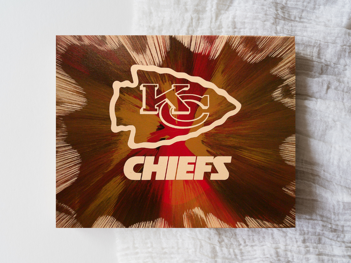 Custom Kansas City Chiefs Football wall art created using spin‑art technique with bold team‑color patterns