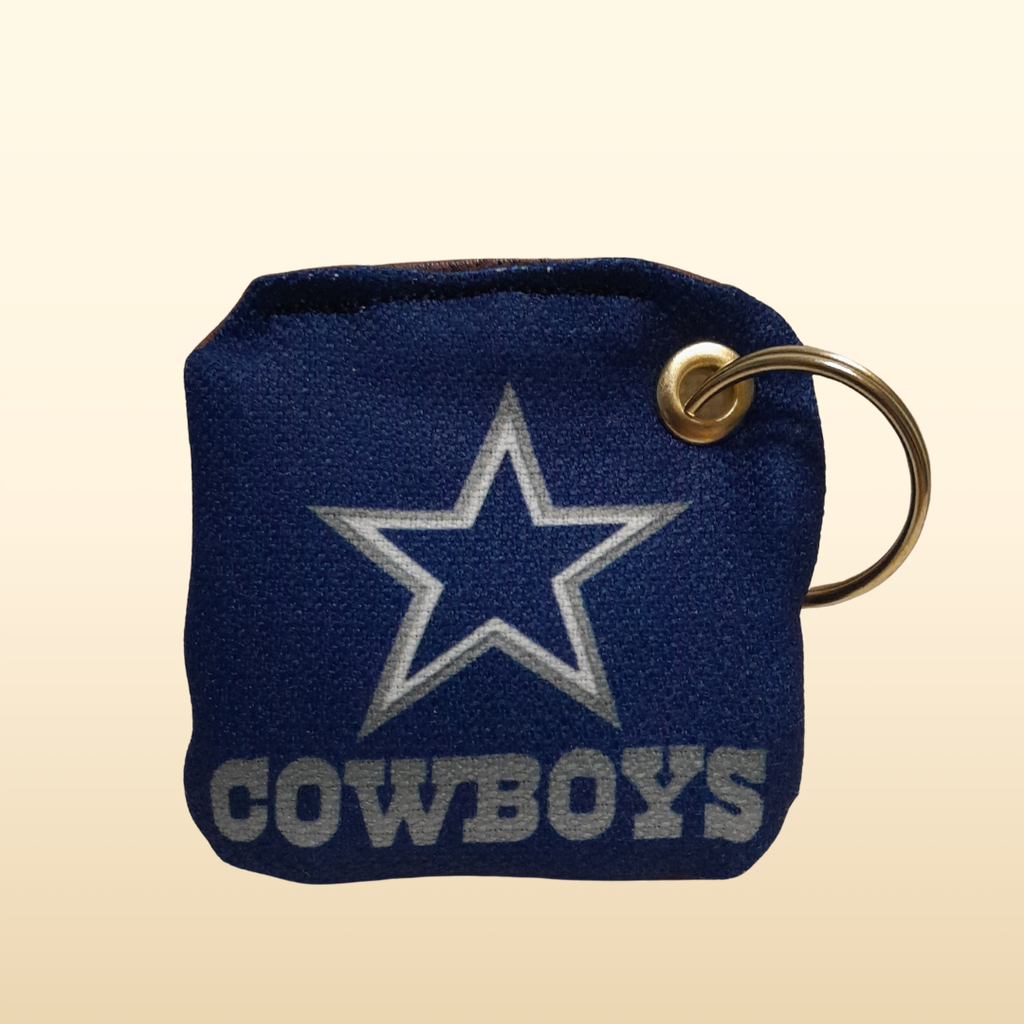 Dallas Cowboys keychain with star logo on a beige background
