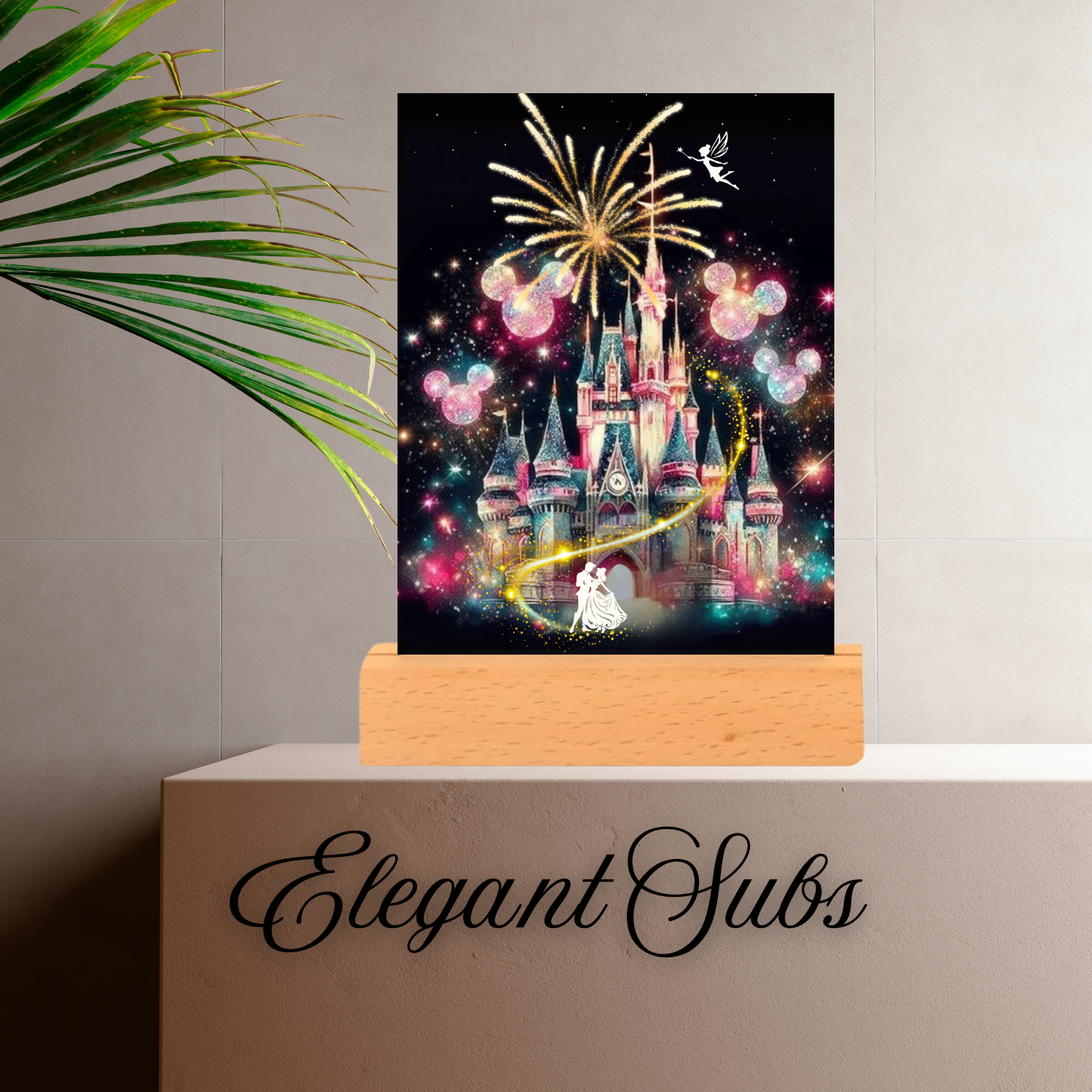 Decorative LED night light of a castle with fireworks on a wooden stand, branded 'Elegant Subs'.