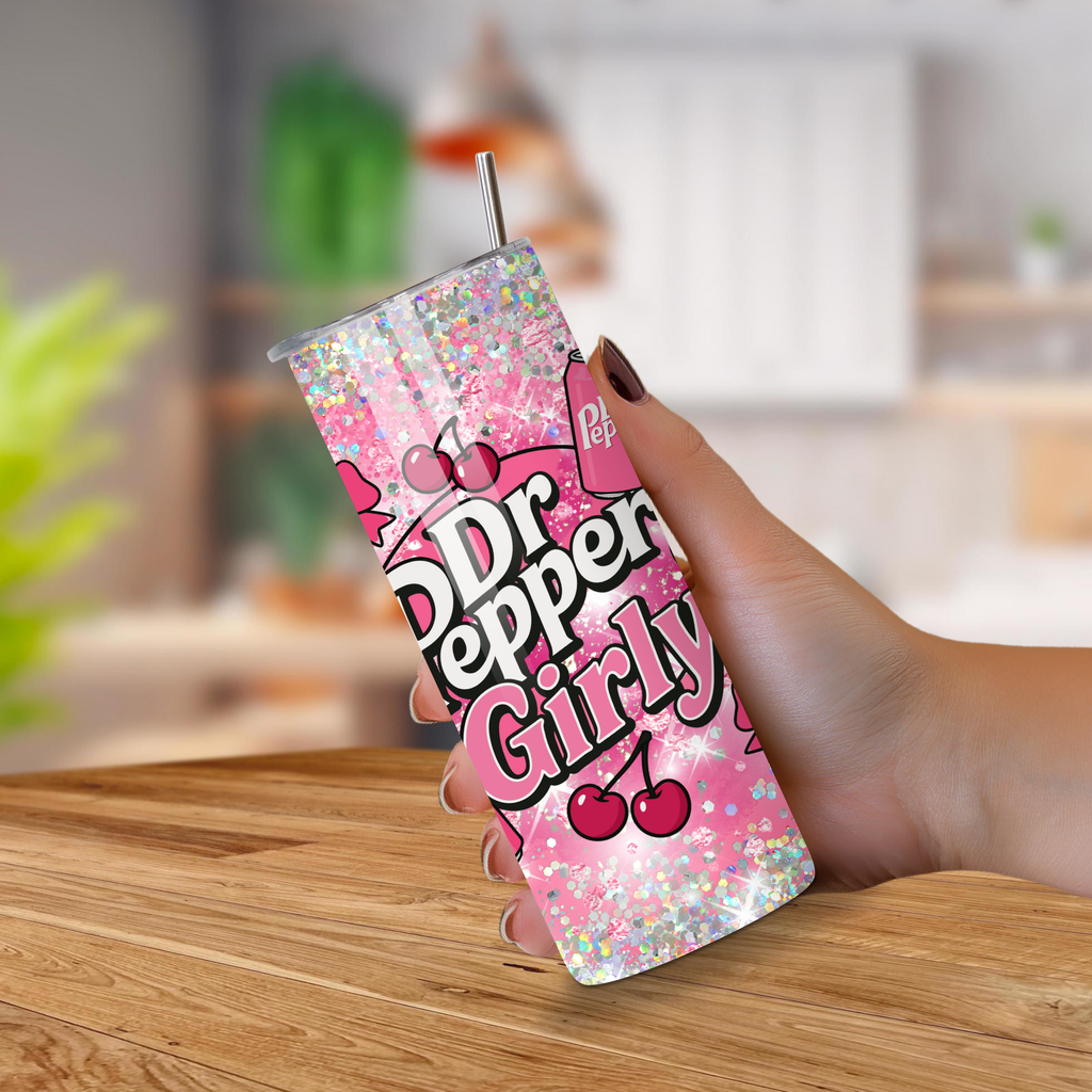 Dr Pepper Girly tumbler with pink design held by a hand on a wooden surface.