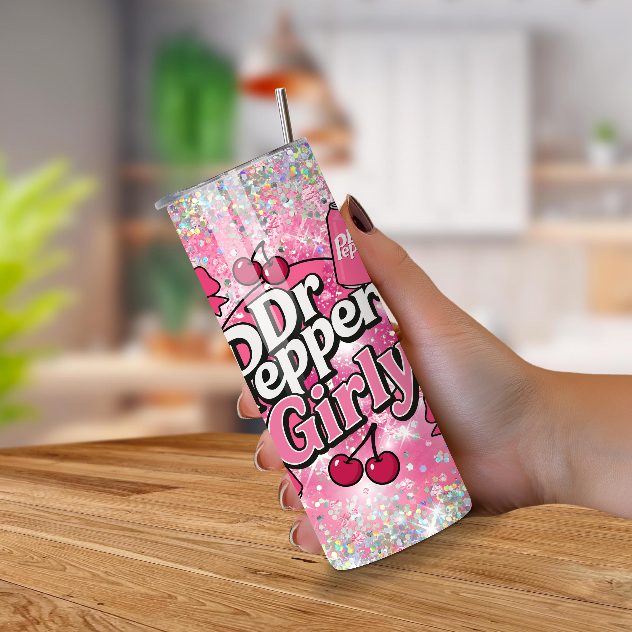 Dr Pepper Girly tumbler with pink design held by a hand on a wooden surface.