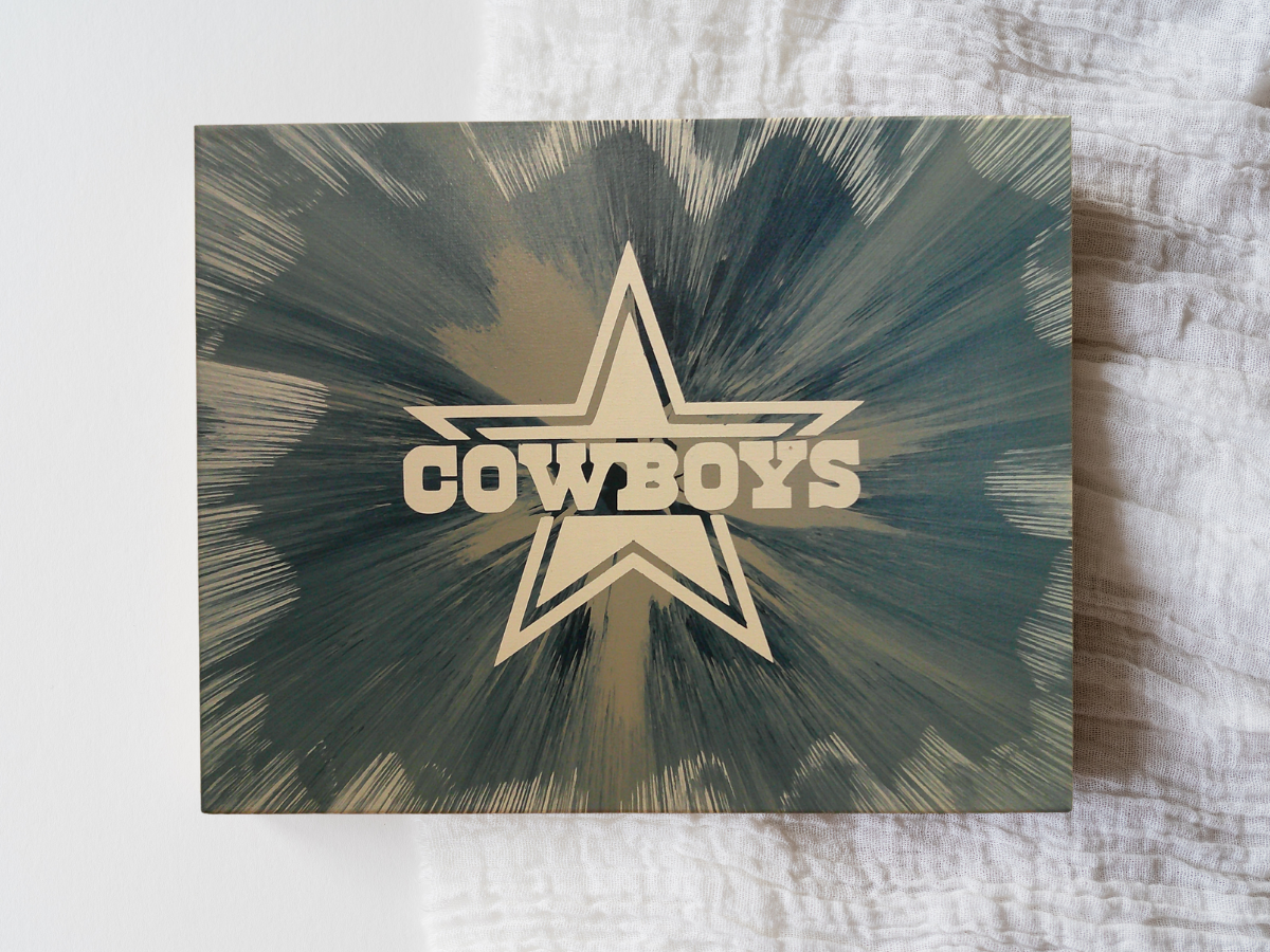 Spin Art canvas of Cowboys logo with star design on a textured surface