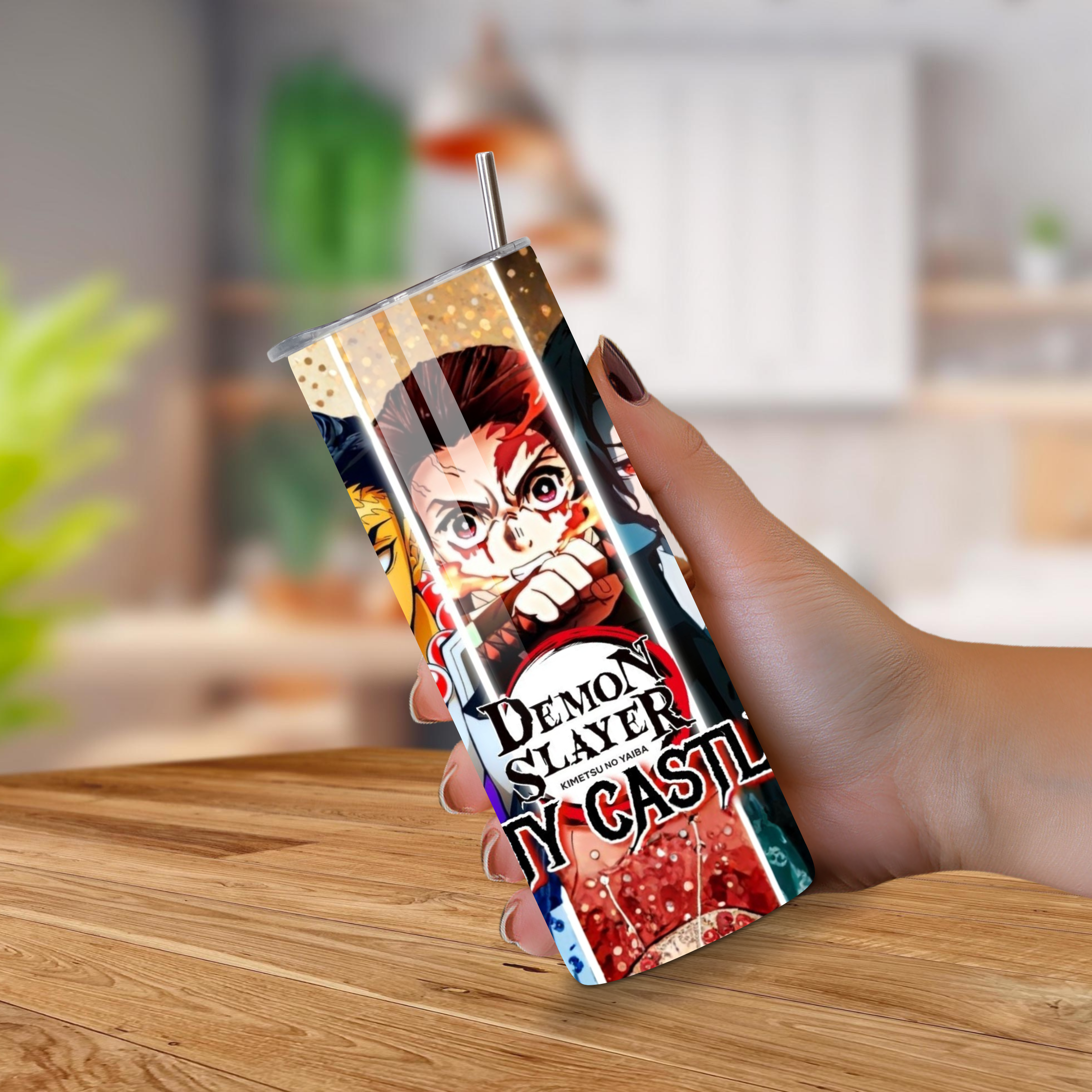 Tumbler with 'Demon Slayer' design held by a hand on a wooden surface