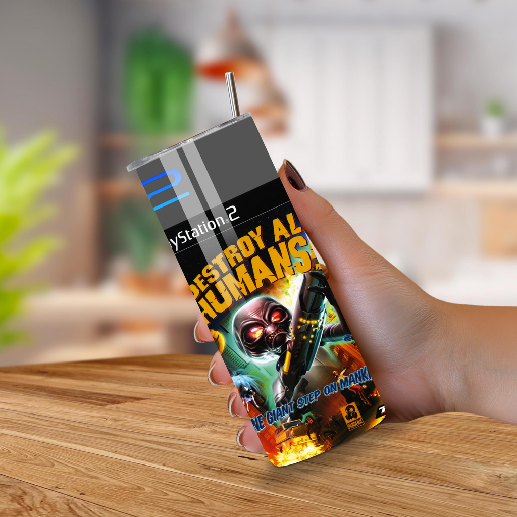 Person holding a 20oz tumbler with Destroy All Humans design on a wooden surface
