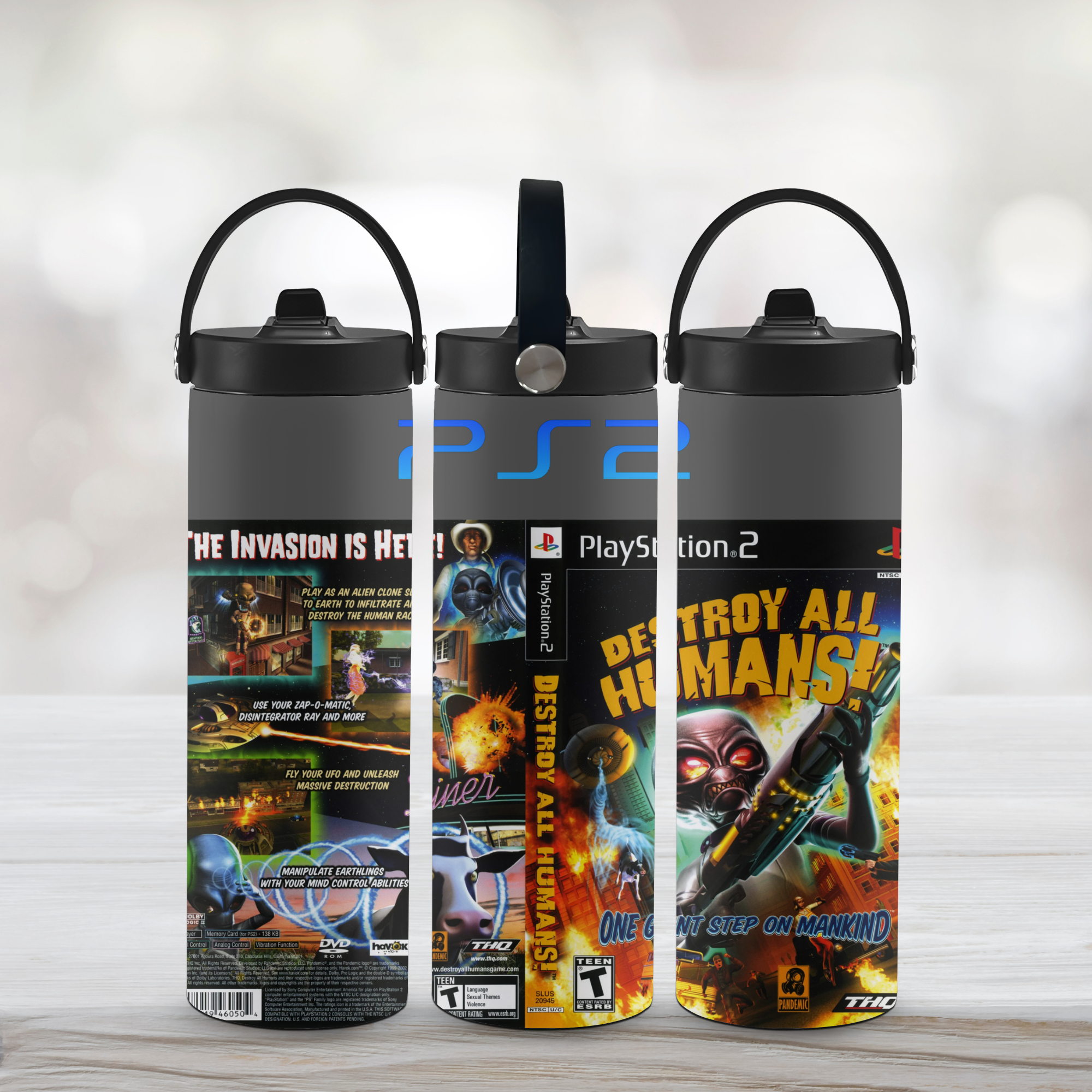 Three sports water bottles with Destroy All Humans covers on a light background