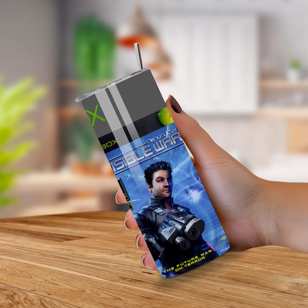 Person holding a 20oz tumbler with a 'Deus Ex Invisible War' design on a wooden surface