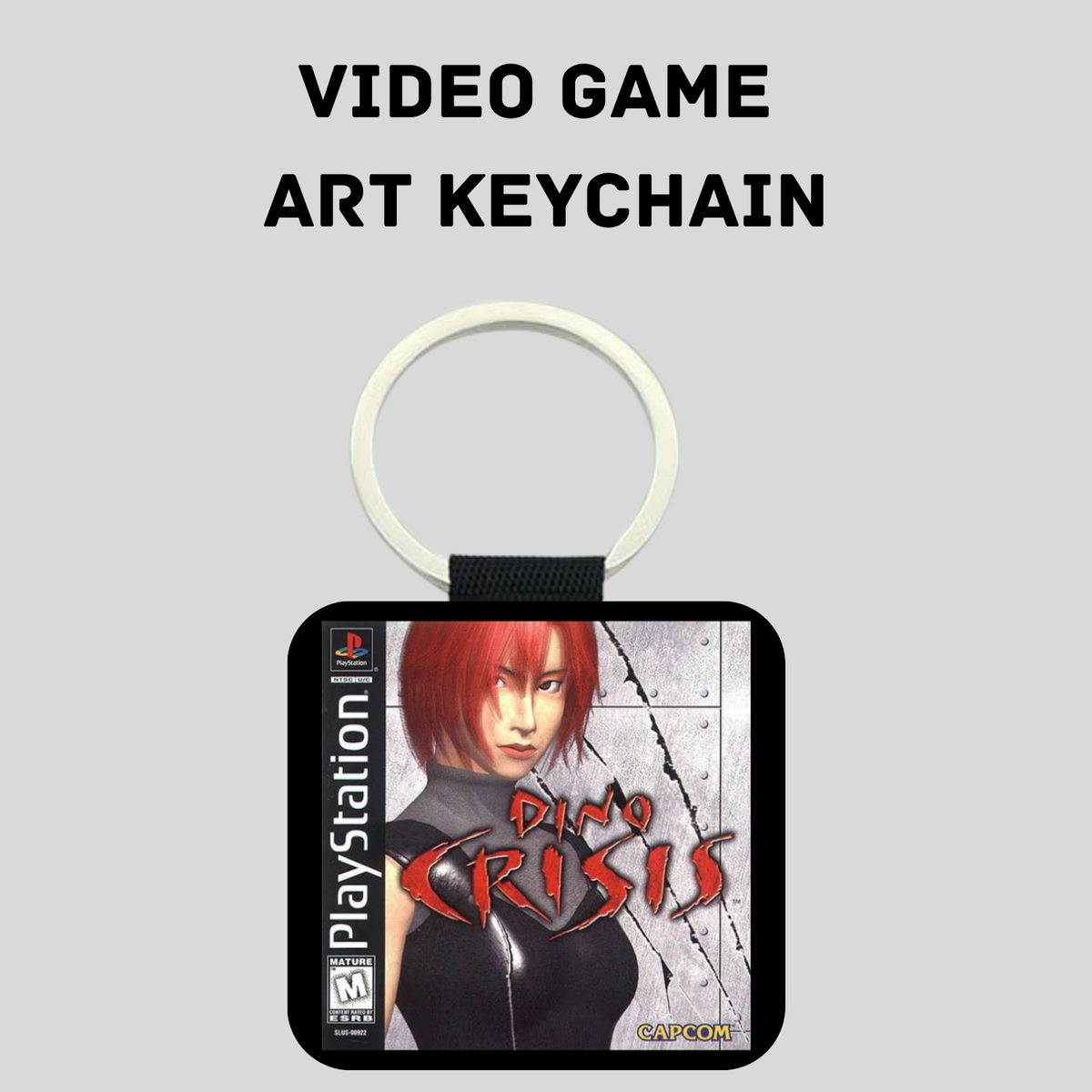 A PlayStation-themed art keychain featuring a square pendant with artwork from the video game 'Dino Crisis' and a white split ring, shown on a light gray background with the text 'VIDEO GAME ART KEYCHAIN' above it.