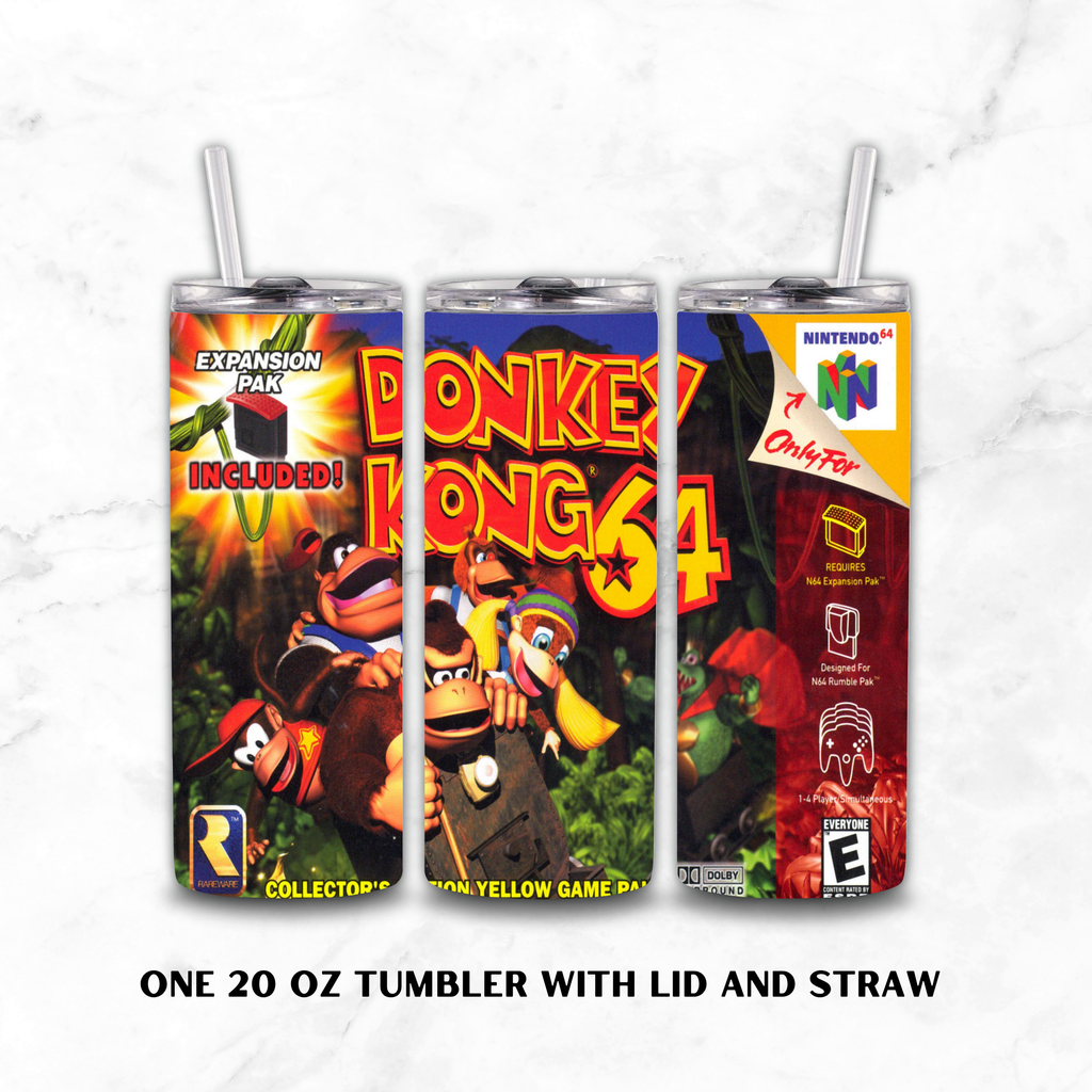 Three views of a 20 oz tumbler with lid and straw, featuring colorful Donkey Kong 64 collector's edition artwork. The tumblers display the front, back, and side designs with Nintendo 64 branding, set against a white marble background with text reading 'ONE 20 OZ TUMBLER WITH LID AND STRAW'.