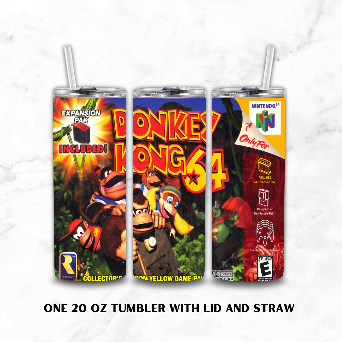 Three views of a 20 oz tumbler with lid and straw, featuring colorful Donkey Kong 64 collector's edition artwork. The tumblers display the front, back, and side designs with Nintendo 64 branding, set against a white marble background with text reading 'ONE 20 OZ TUMBLER WITH LID AND STRAW'.