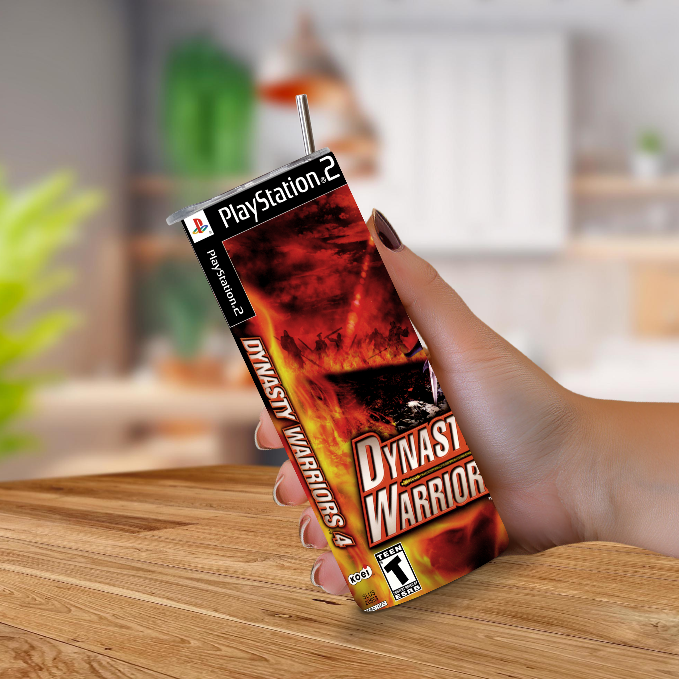 A hand holding a 20oz tumbler PlayStation 2 game designed to look like Dynasty Warrior 4 cover art, with a straw inserted at the top.