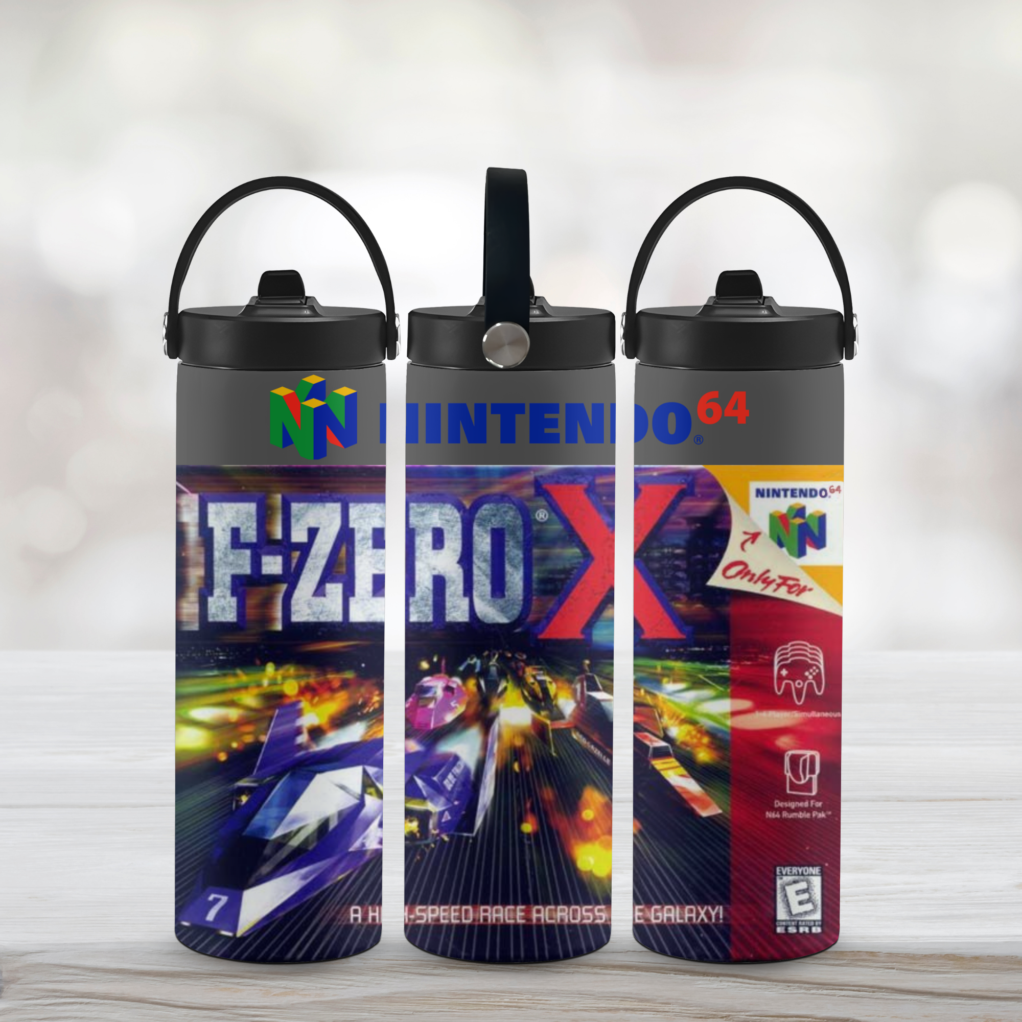 Three water bottles with F-Zero X design on a light wooden surface.