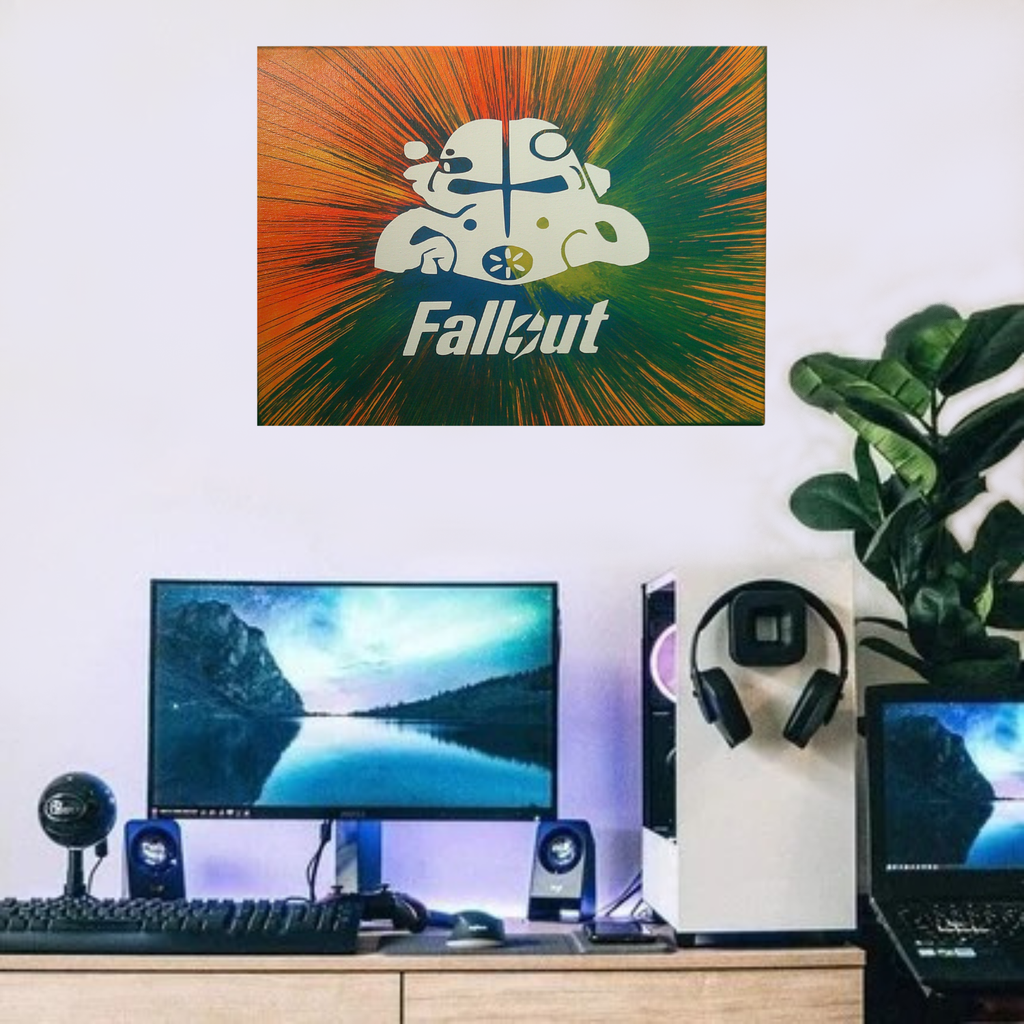 Gaming setup with 'Fallout' spin art canvas on the wall, computer monitor, keyboard, and speakers.