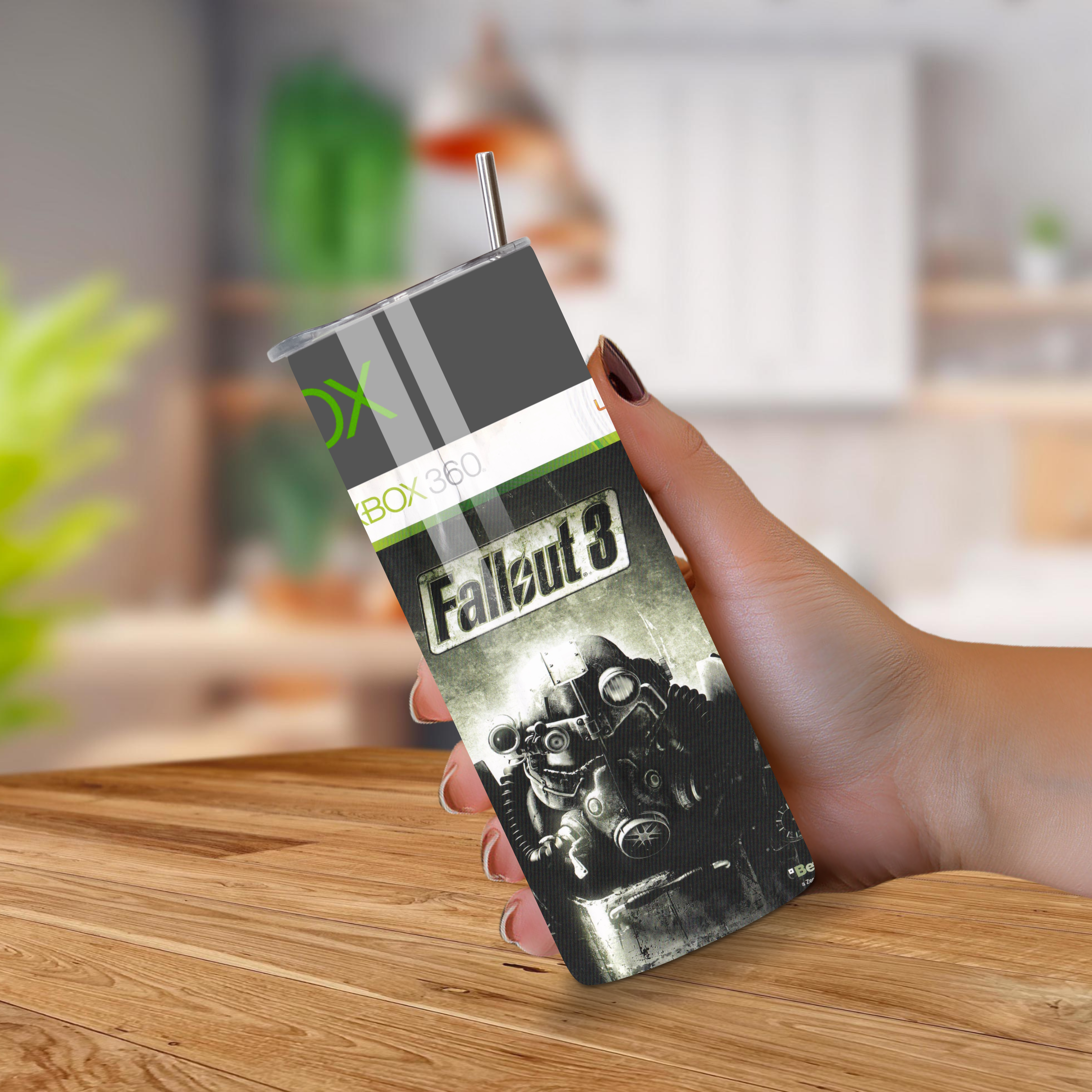 20oz Tumbler with 'Fallout 3' design held by a hand on a wooden surface