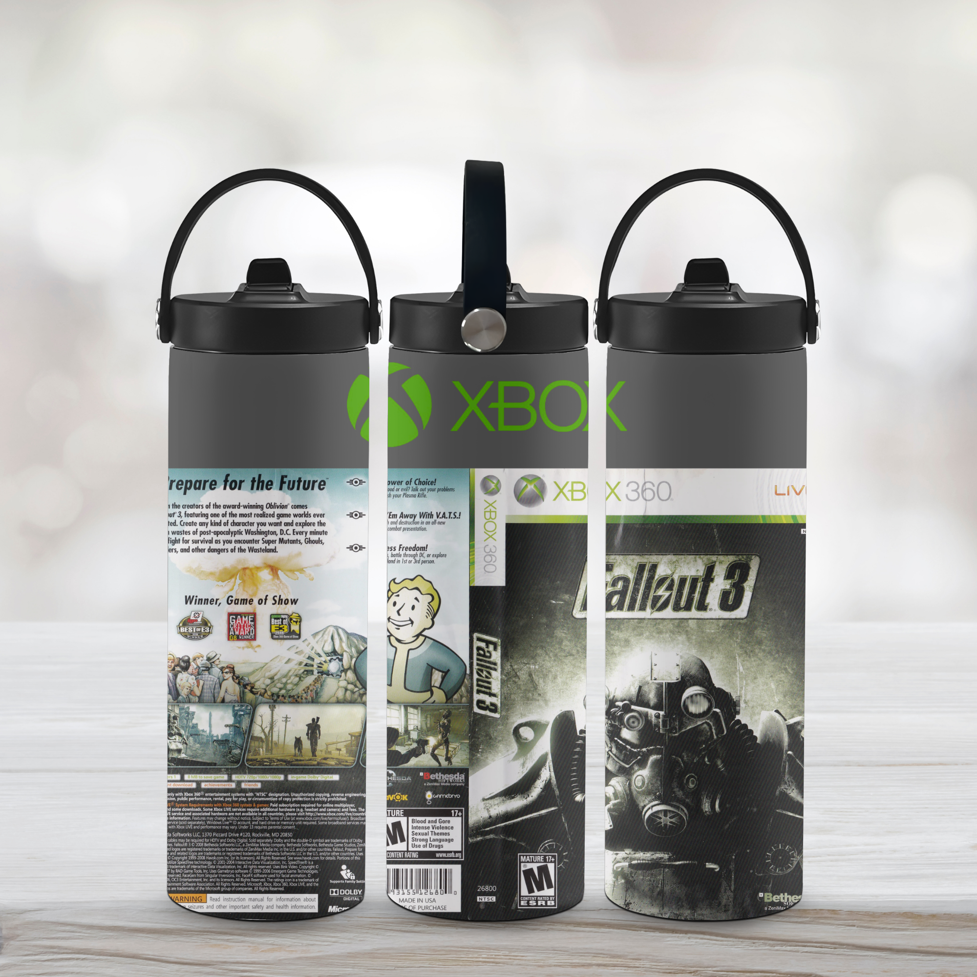 Three sports water bottle designs featuring Xbox and Fallout 3 branding on a light wooden surface.