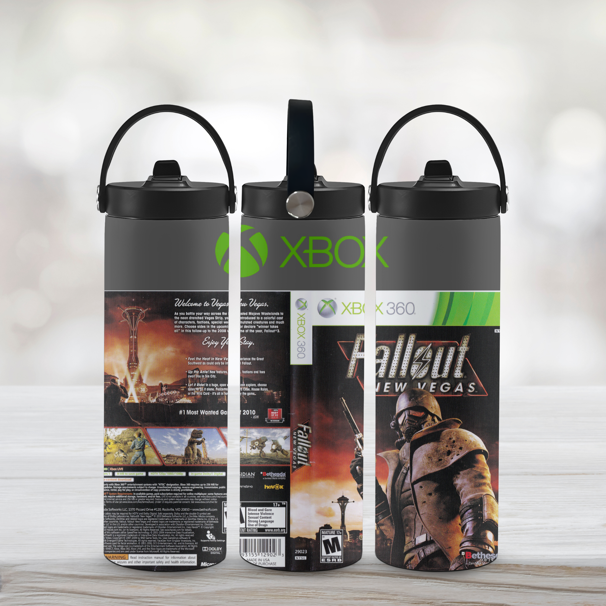 Three water bottles with 'Xbox' and 'Fallout New Vegas' designs on a light background