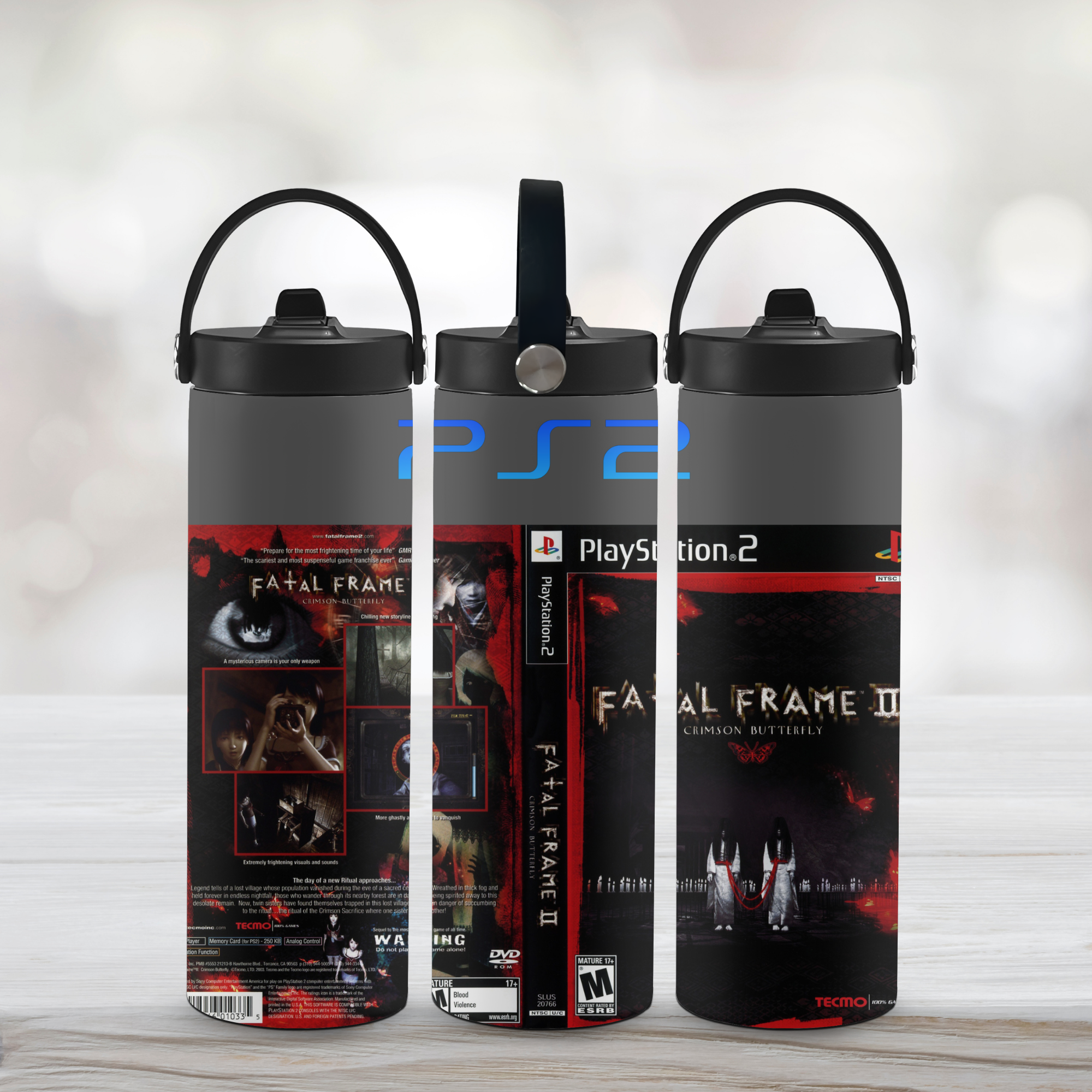 Three sports water bottle with 'Fatal Frame' and 'PlayStation 2' branding on a light wooden surface.