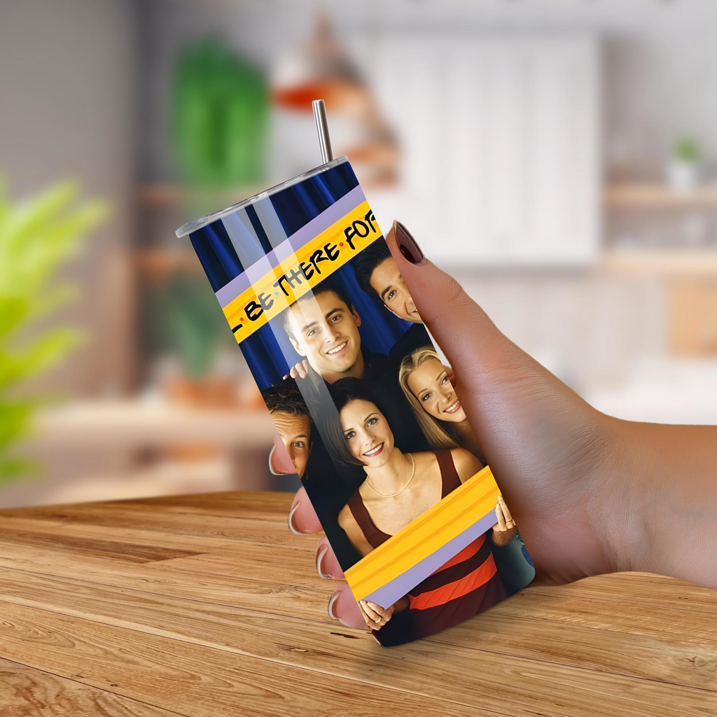 Tumbler with Friends TV Show design on a wooden table.